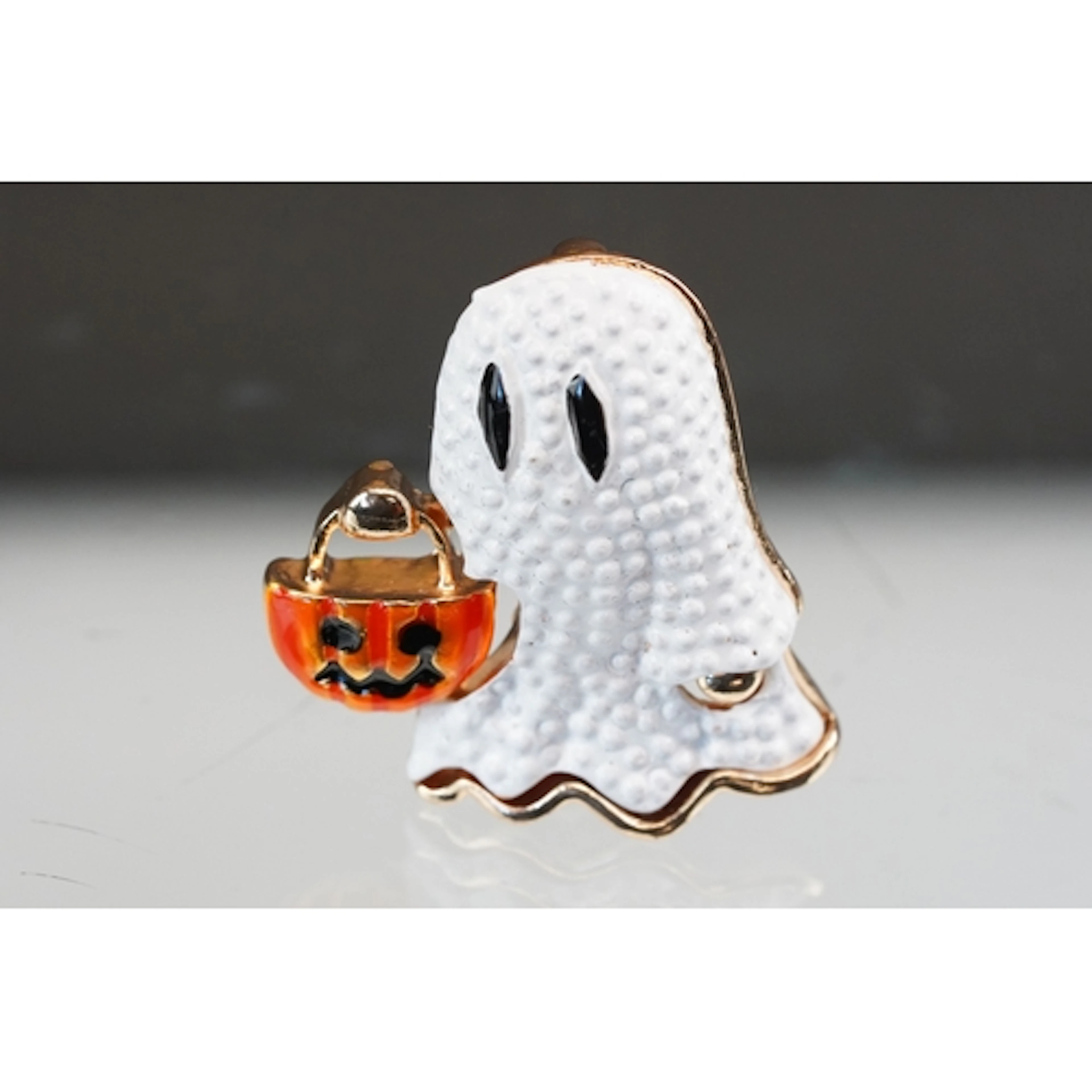 A contemporary gold tone spooky Halloween brooch in the form...