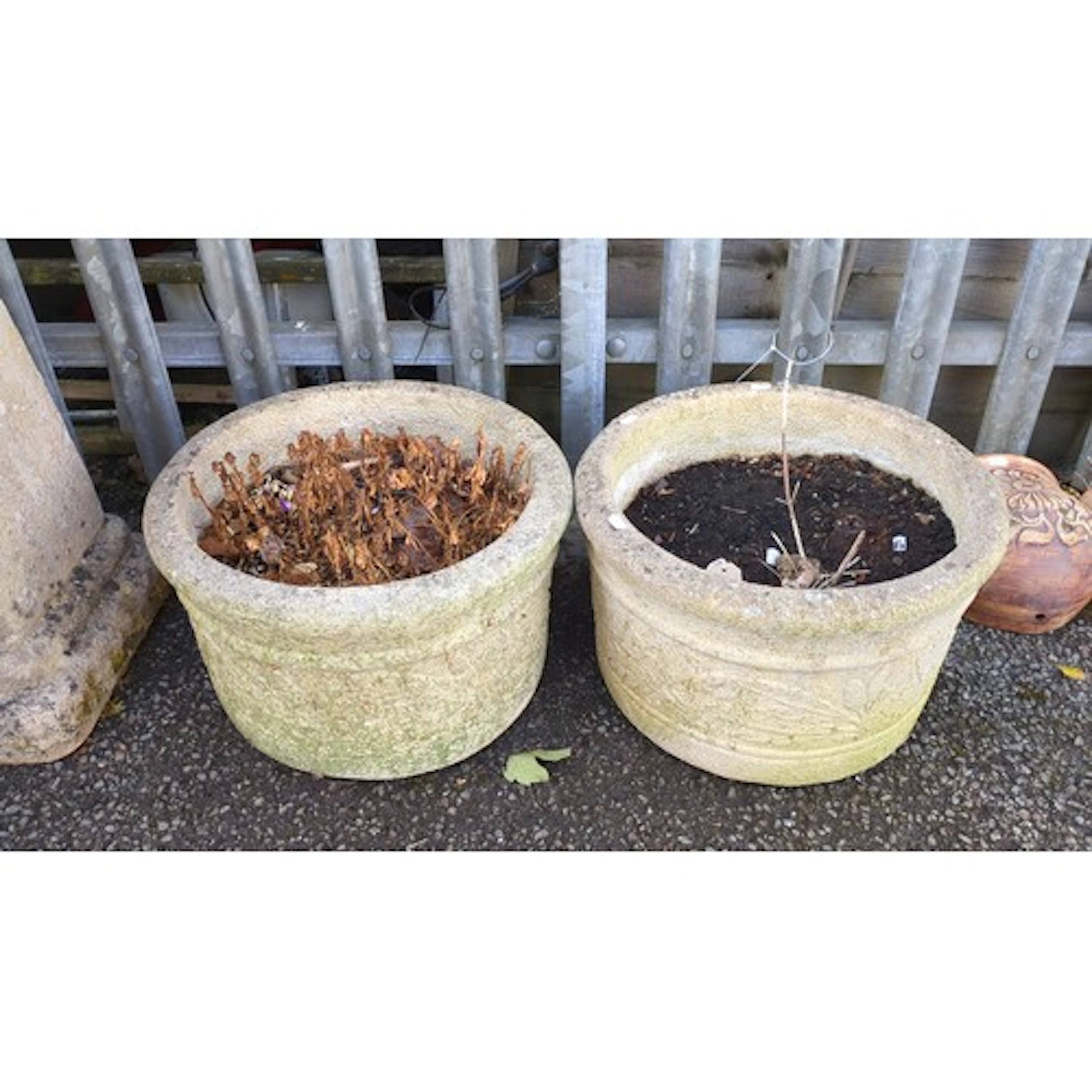 A pair of reconstituted stone garden planters, of deep circu...