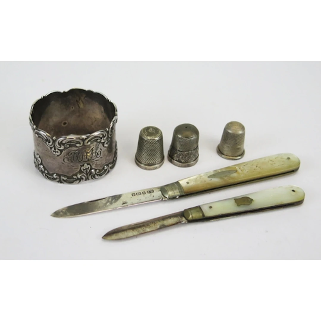 Assorted silverware including three thimbles, a napkin ring ...