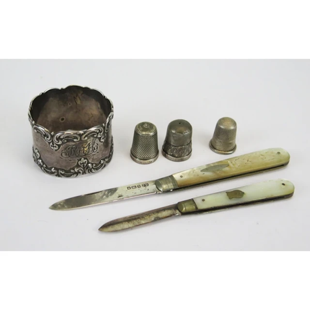 Assorted silverware including three thimbles, a napkin ring ...