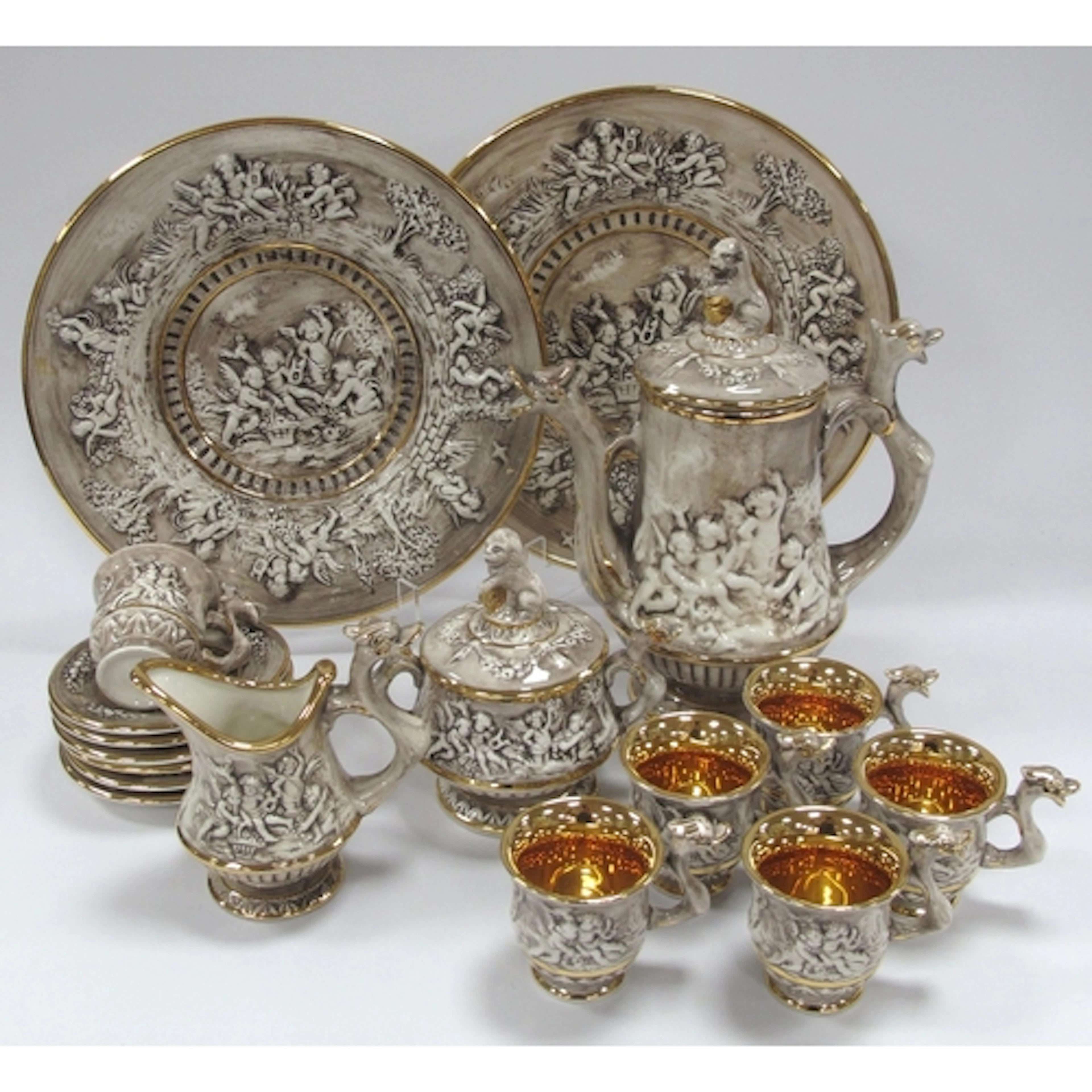 Italian Capodimonte cherub motif lustre coffee set, features...