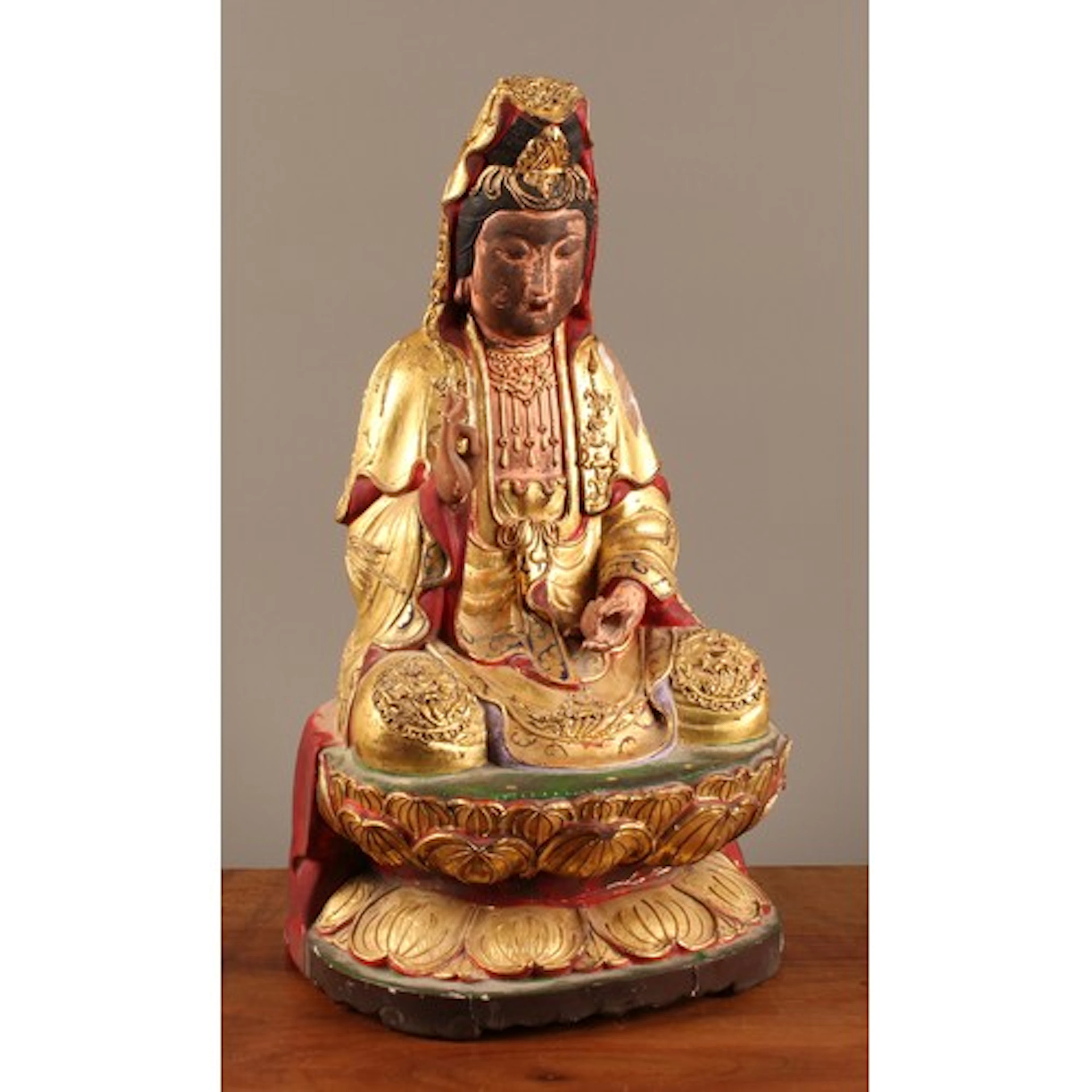 A Chinese polychrome and giltwood and gesso decorated figure...