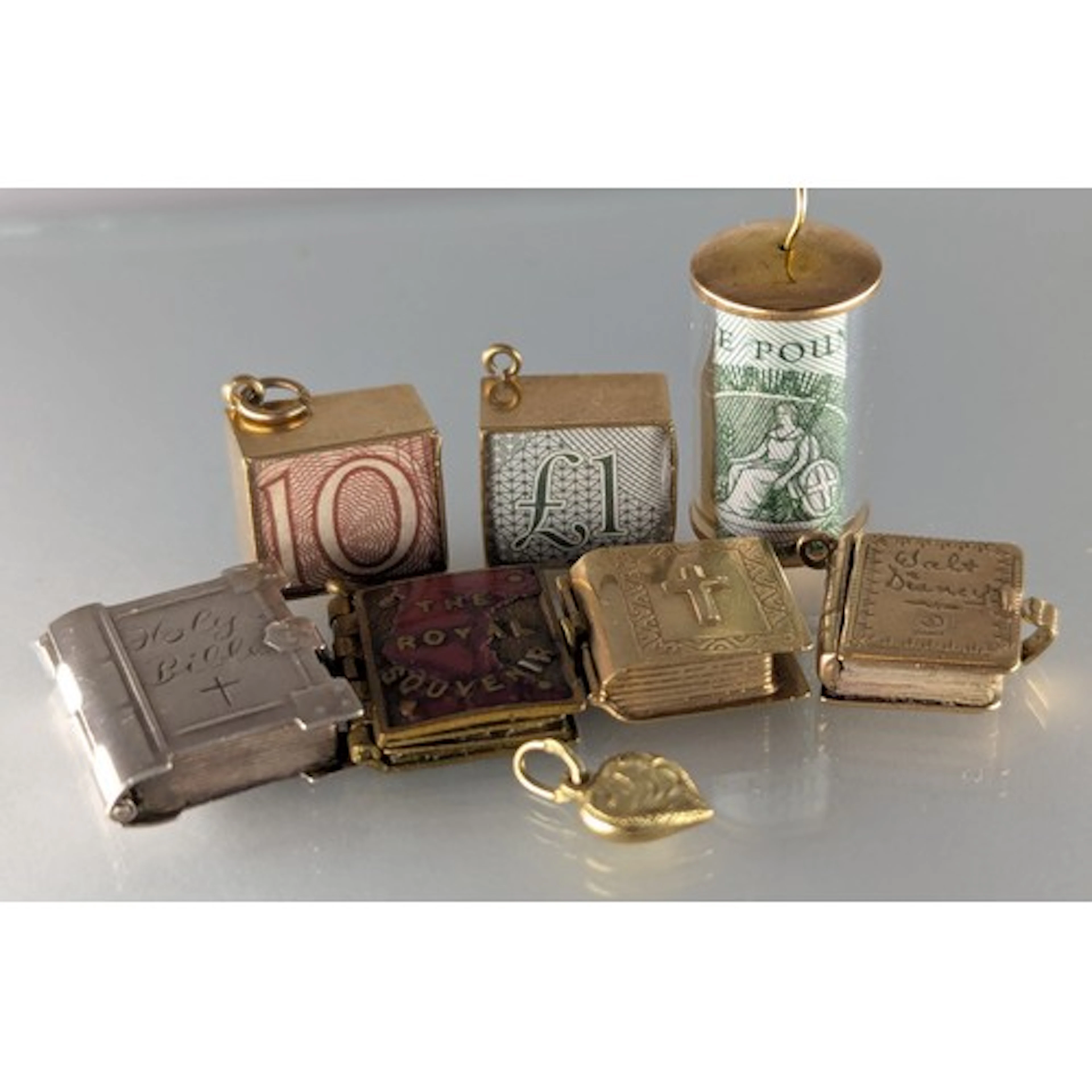 Jewellery - two 9ct gold mounted £1.00 noted charms, another...