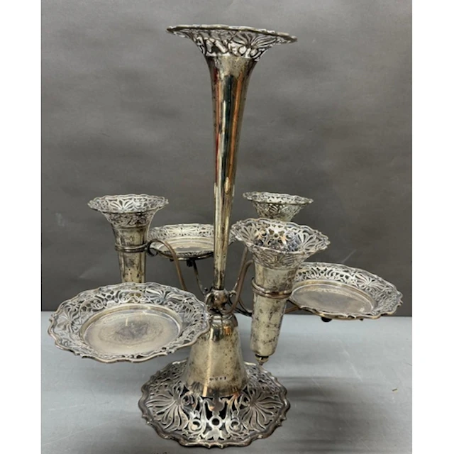 A silver epergne or centrepiece featuring a tall central tru...