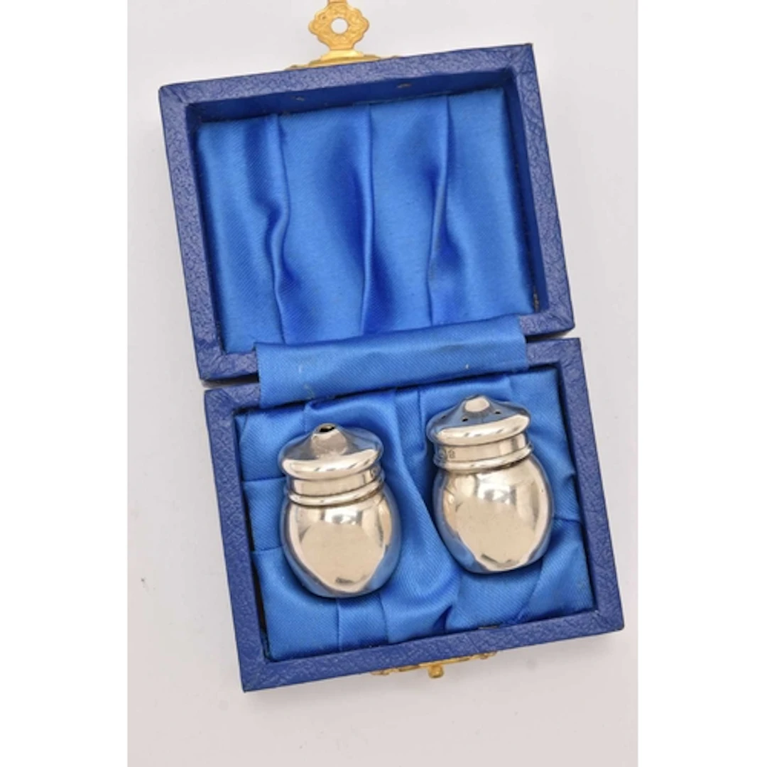 A CASED PAIR OF MINIATURE SILVER SALT AND PEPPER POTS, each ...