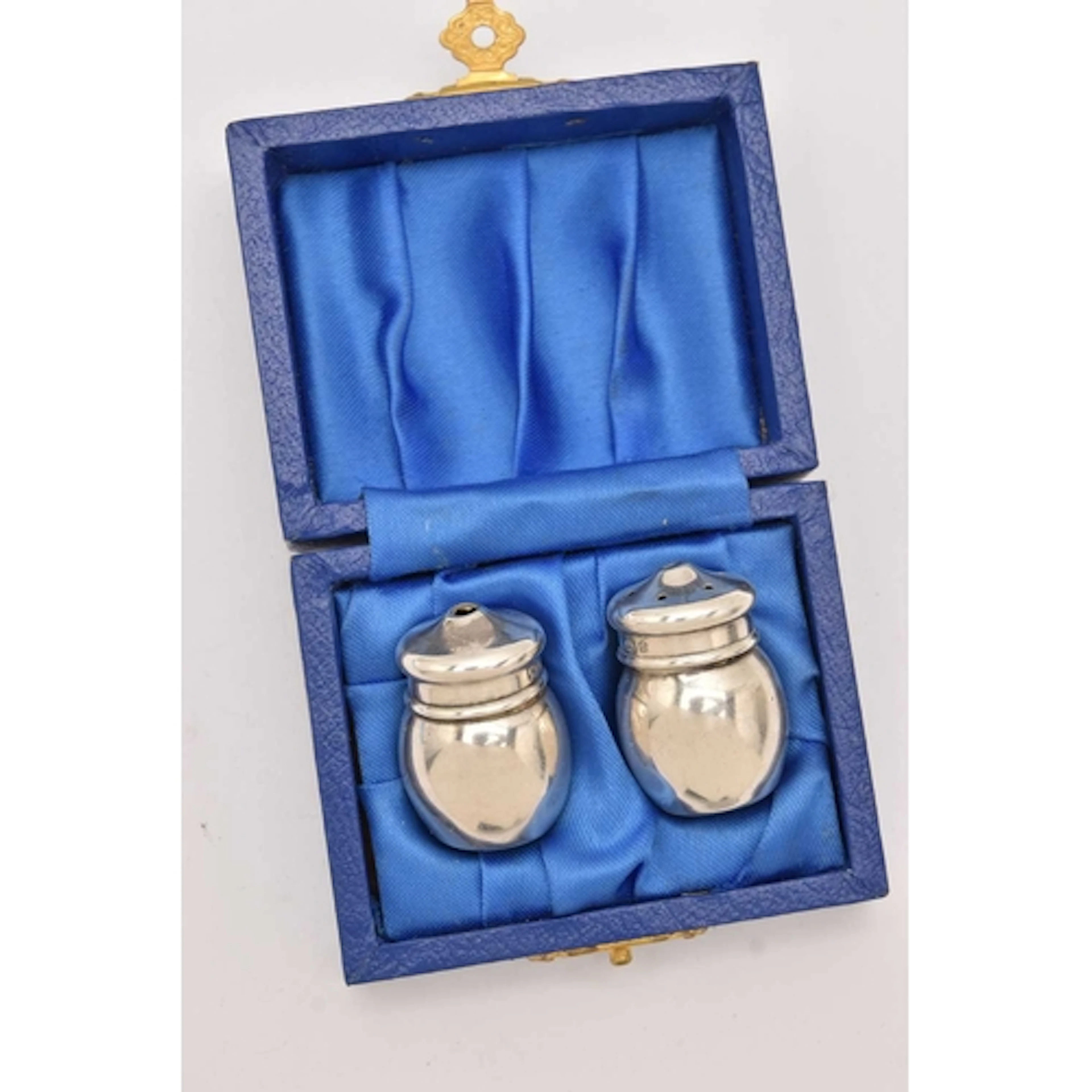 A CASED PAIR OF MINIATURE SILVER SALT AND PEPPER POTS, each ...