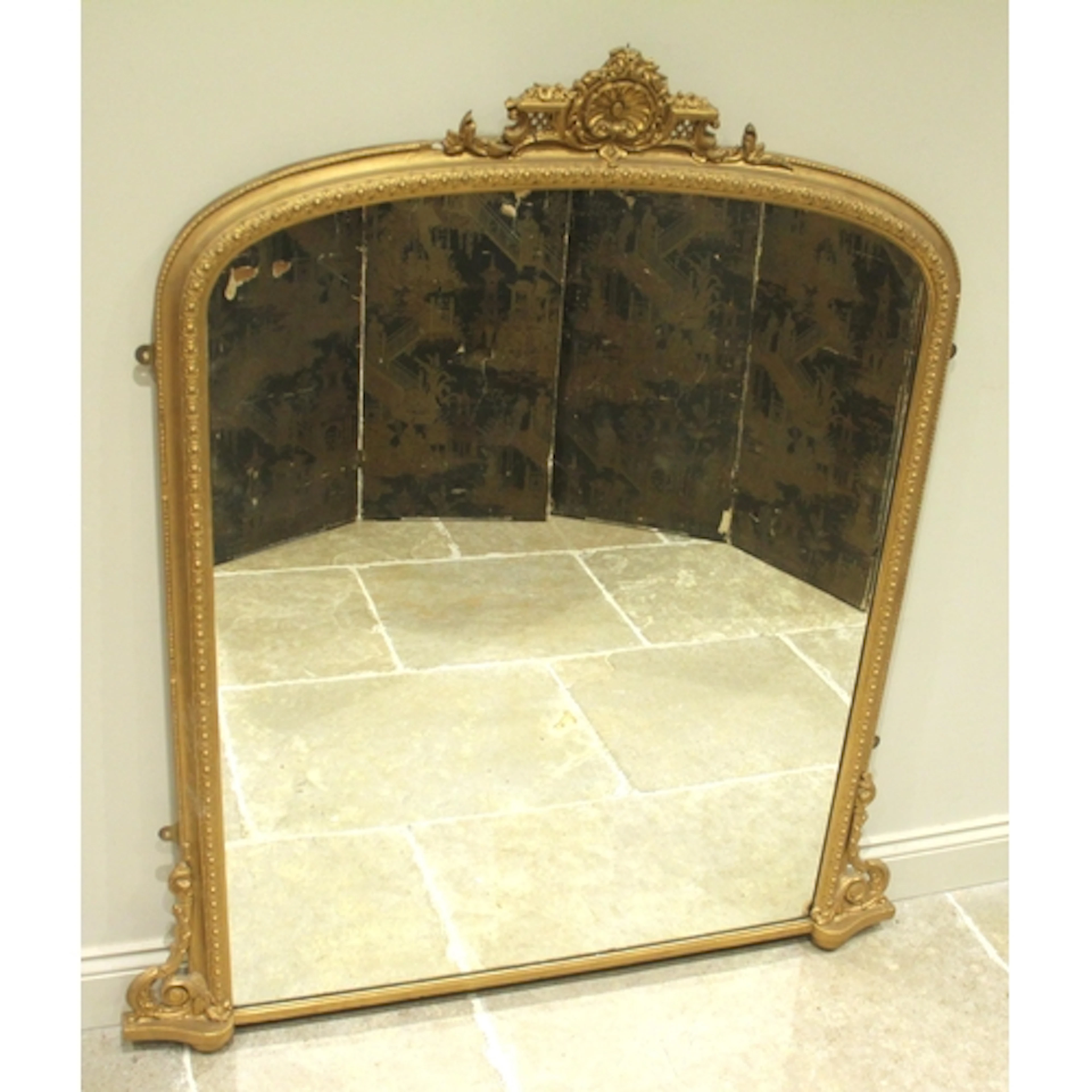 A Victorian style composite and gold-painted overmantel mirr...