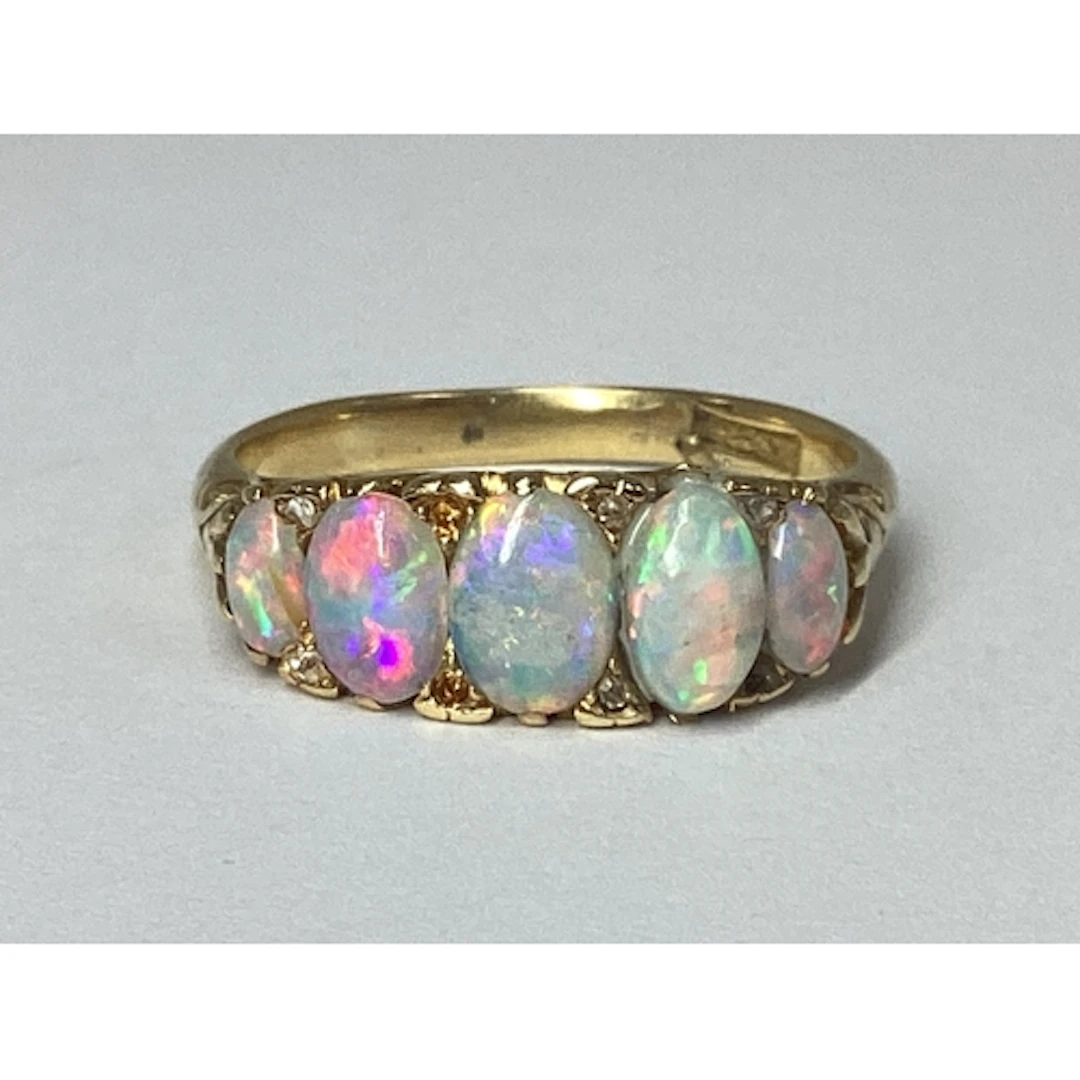A Graduated Five Stone Opal Boat Shape Ring, claw set, with ...