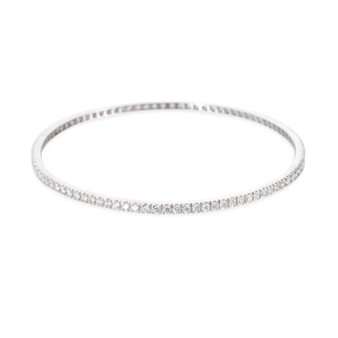 A DIAMOND SET BANGLE, the round brilliant cut diamonds mount...