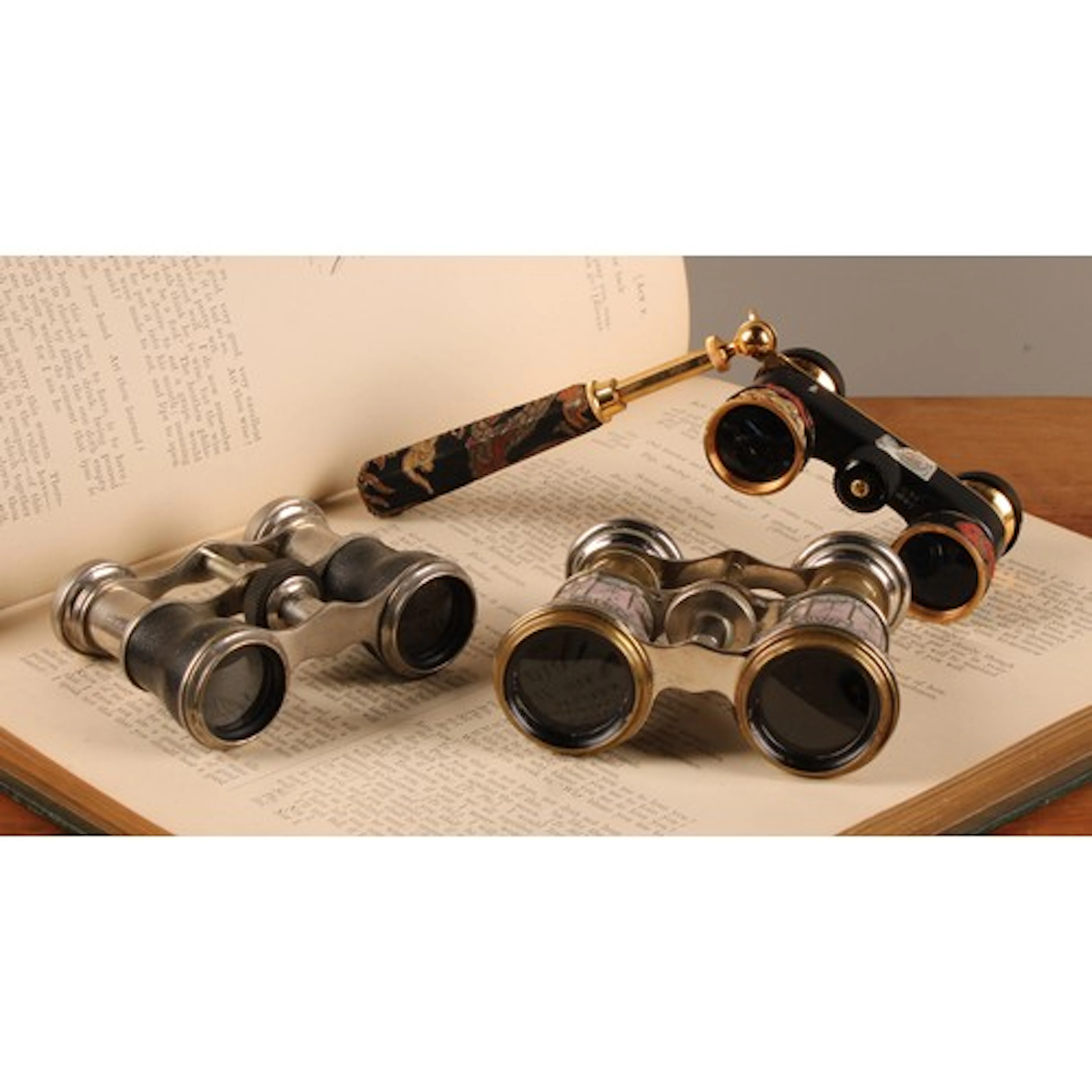 A pair of French white metal and leather bound opera glasses...
