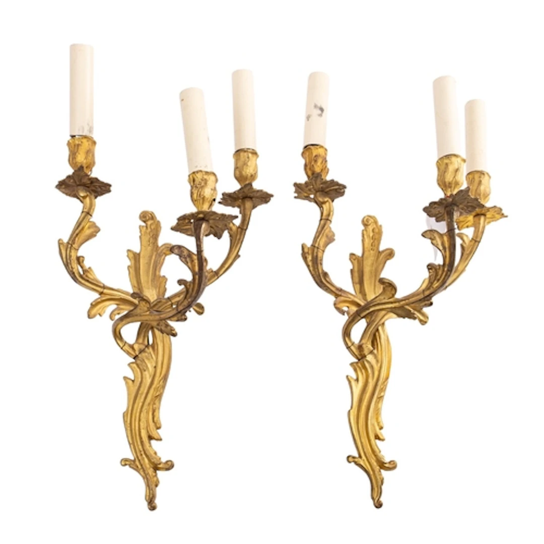 A pair of gilt metal three-light wall appliques in Louis XV ...