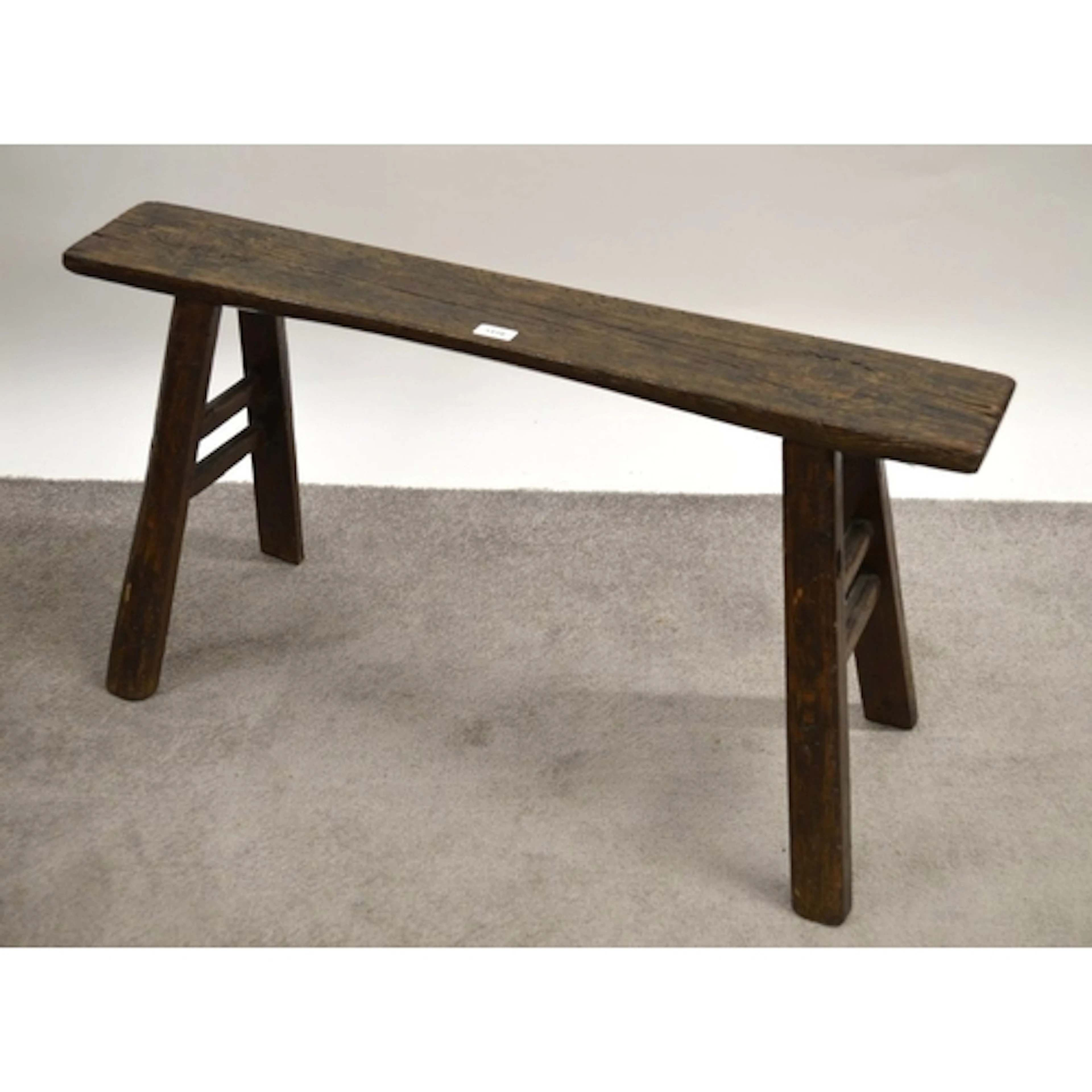 Primitive stained pine narrow bench / sawhorse, on splay sup...