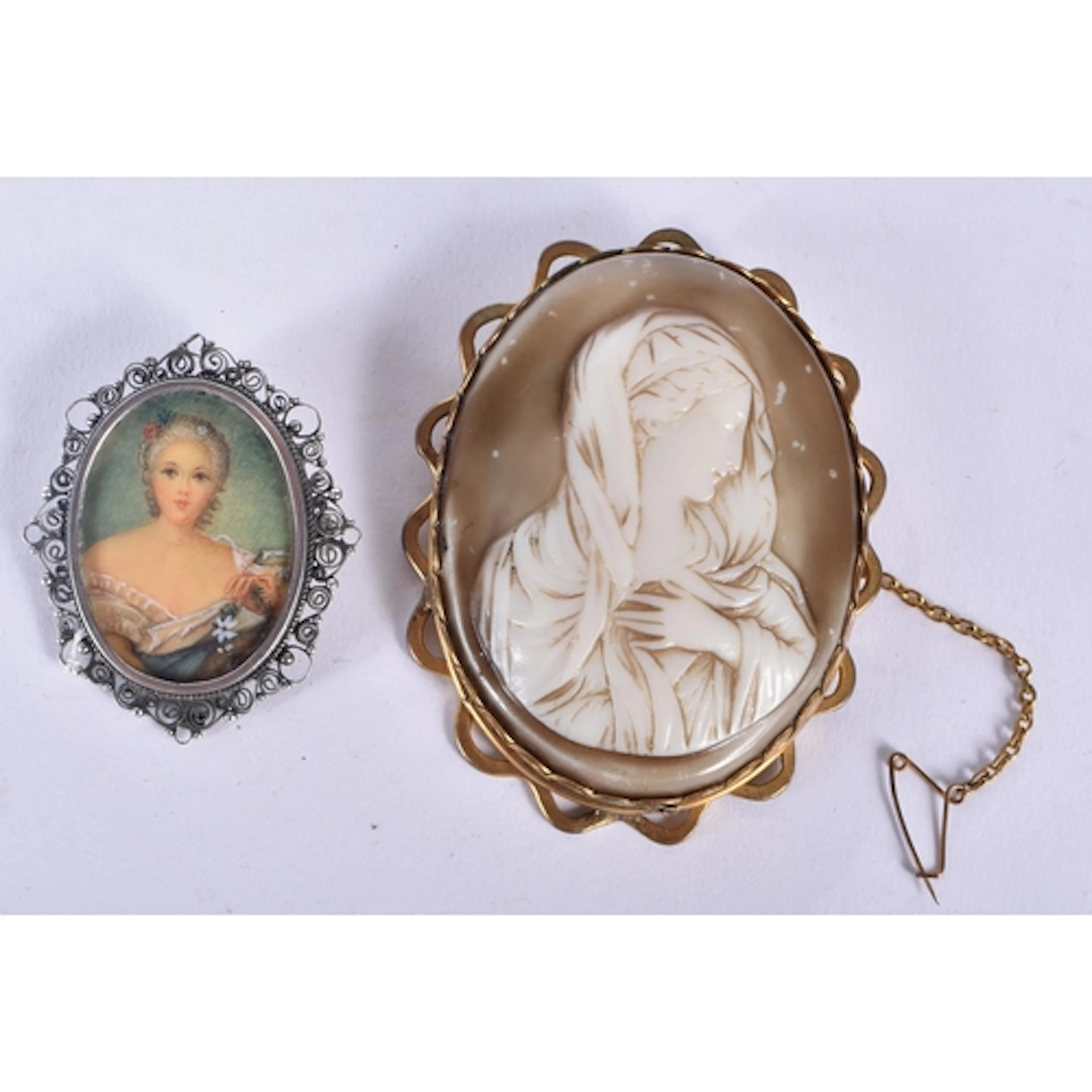 An antique glass cameo relief brooch depicting the Virgin ma...