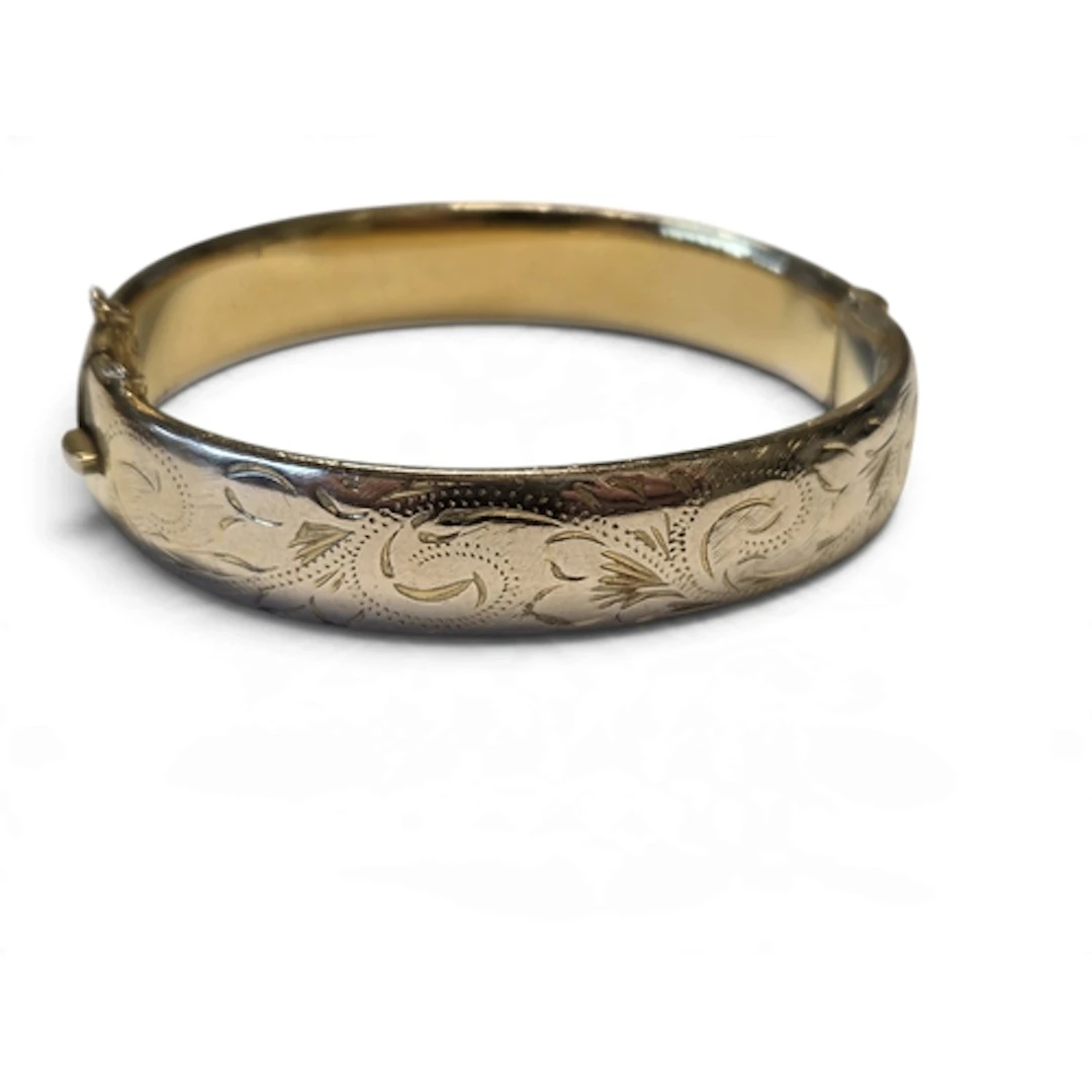 A vintage 9 carat rolled gold. An engraved bangle, consistin...