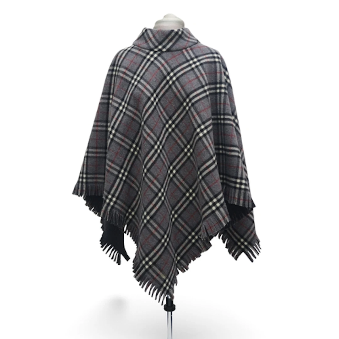 A Burberry wool poncho in grey check with charcoal grey back...