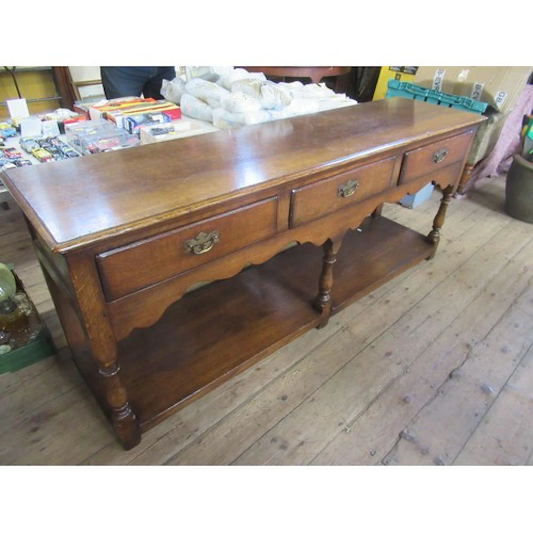 An oak dresser base fitted three short drawers width 72ins ,...