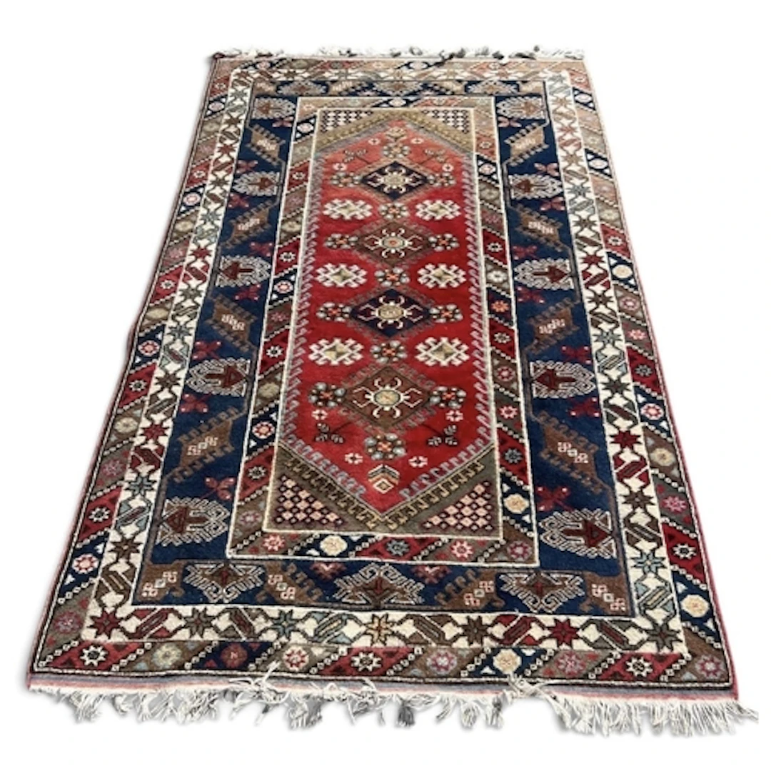 A DOSEMEALTI TURKISH CARPET, THE RED GROUND CENTRE PANEL WIT...