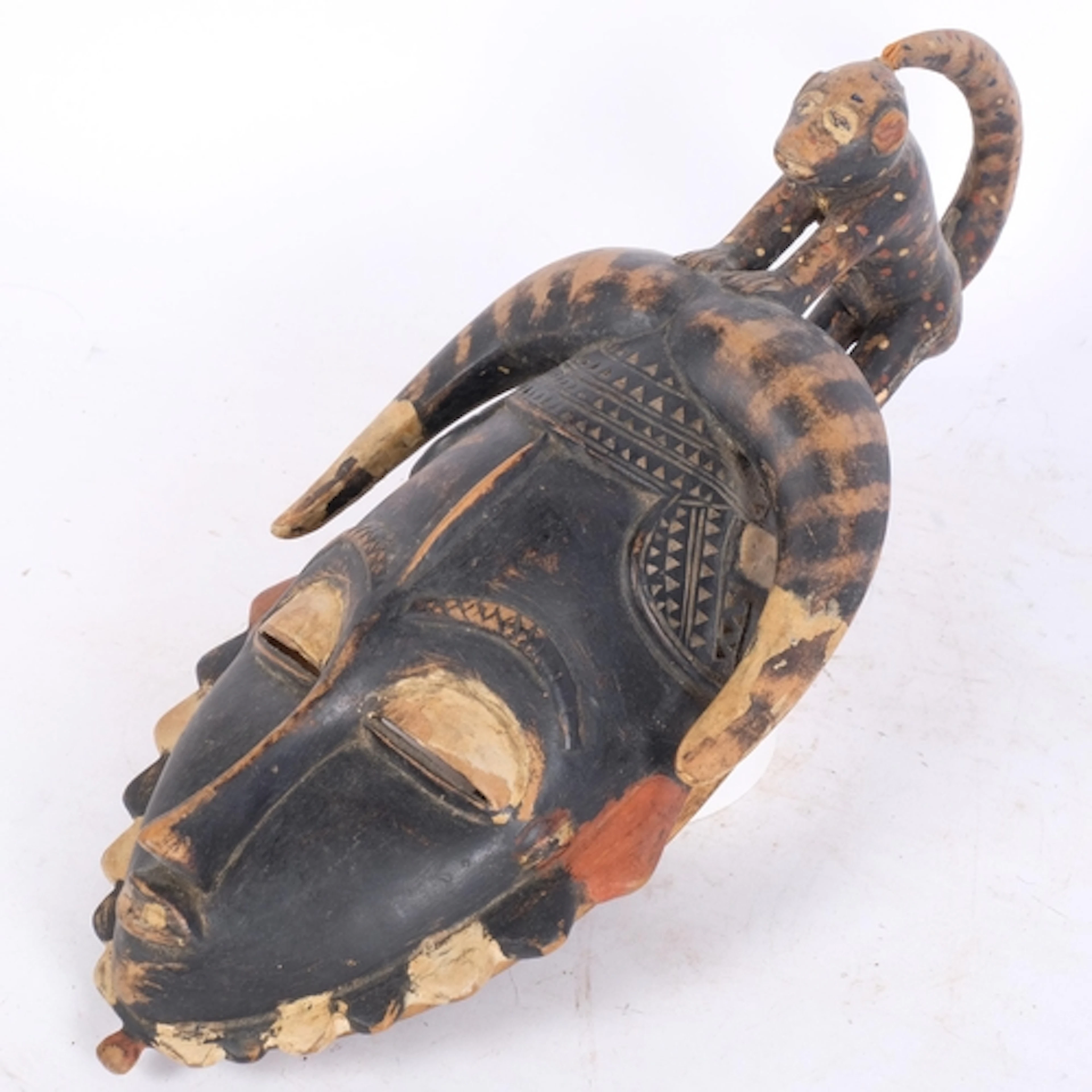 West Africa carved and painted wood Tribal mask, surmounted ...
