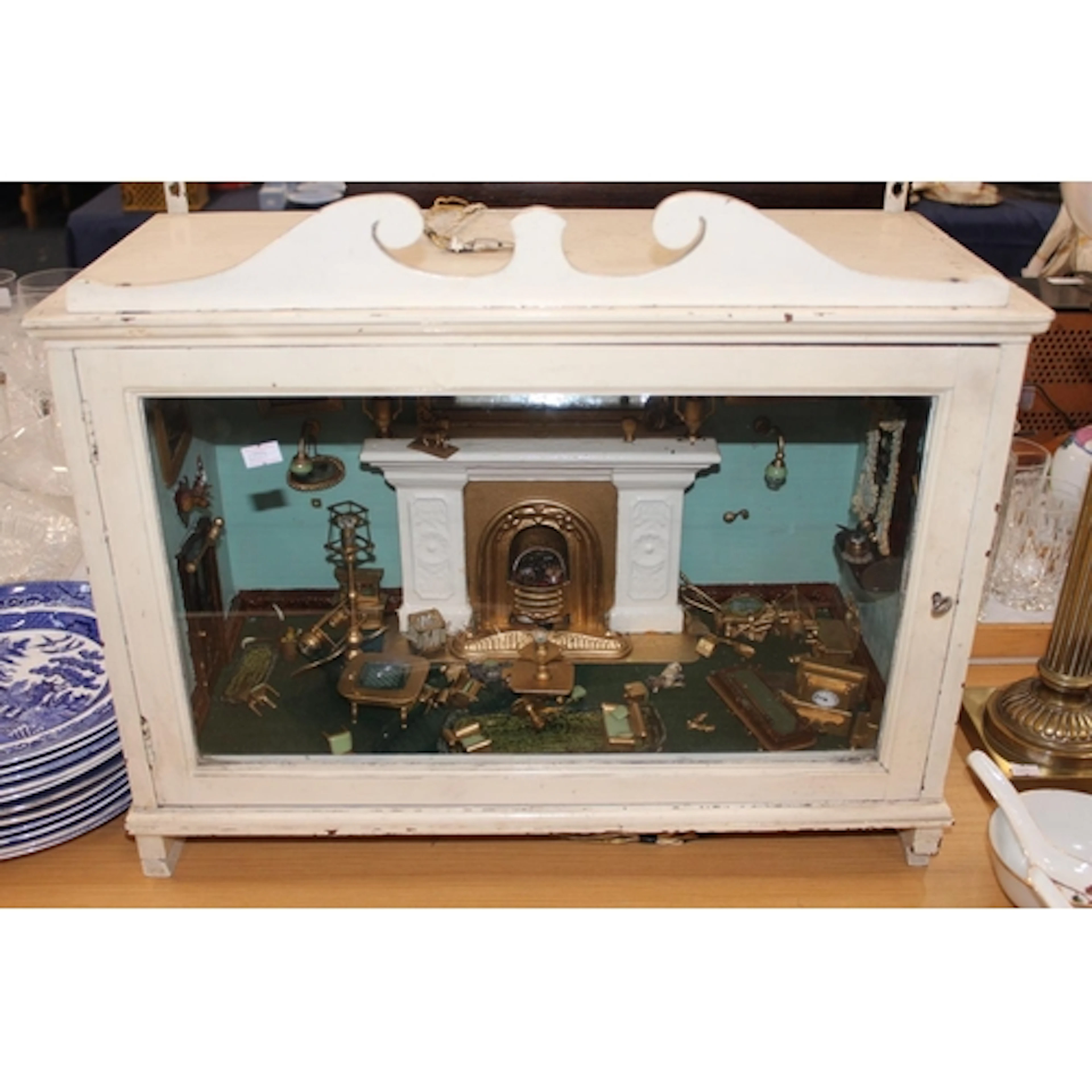 Glass display case featuring a Victorian room setting with f...
