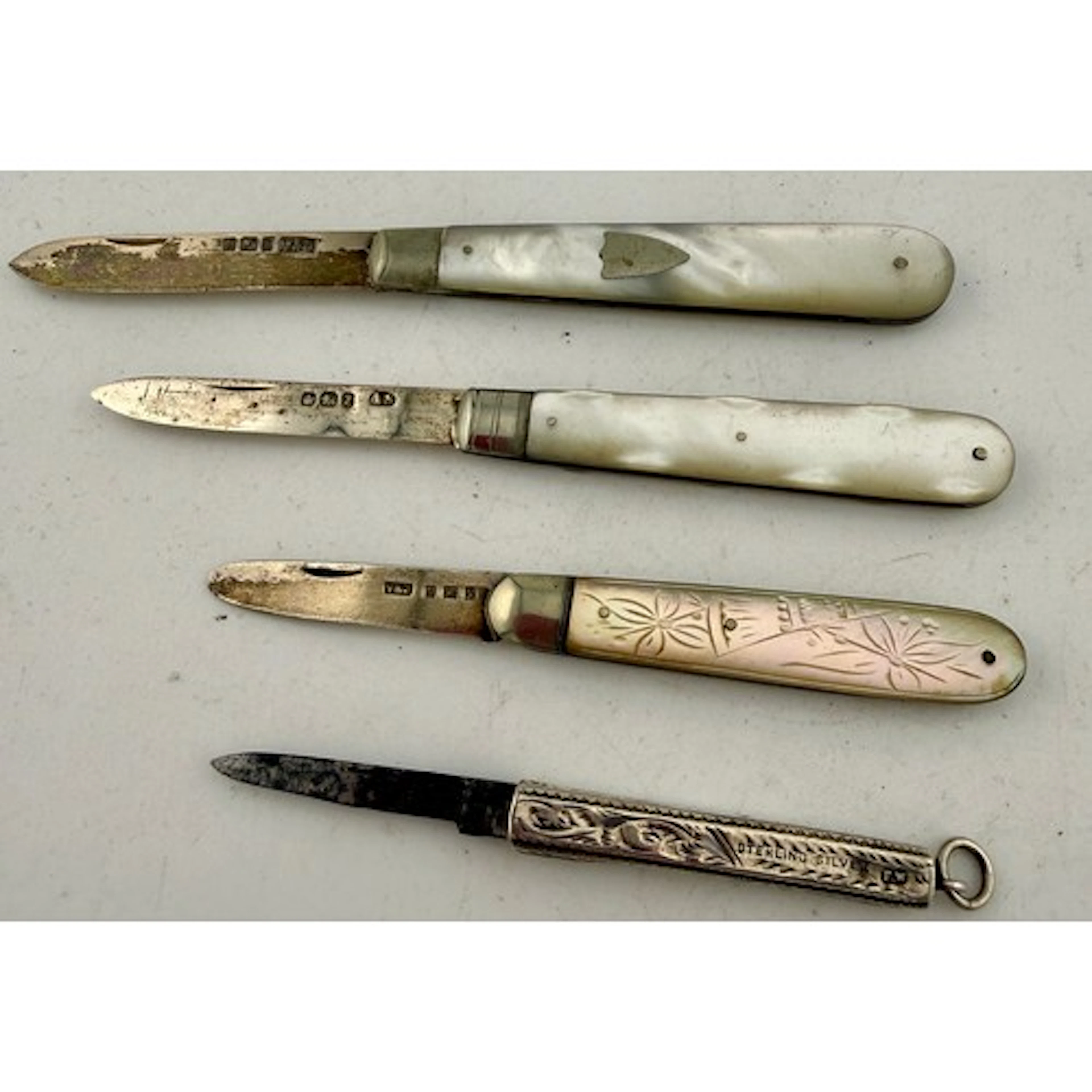 Three silver and mother of pearl fruit knives together with ...