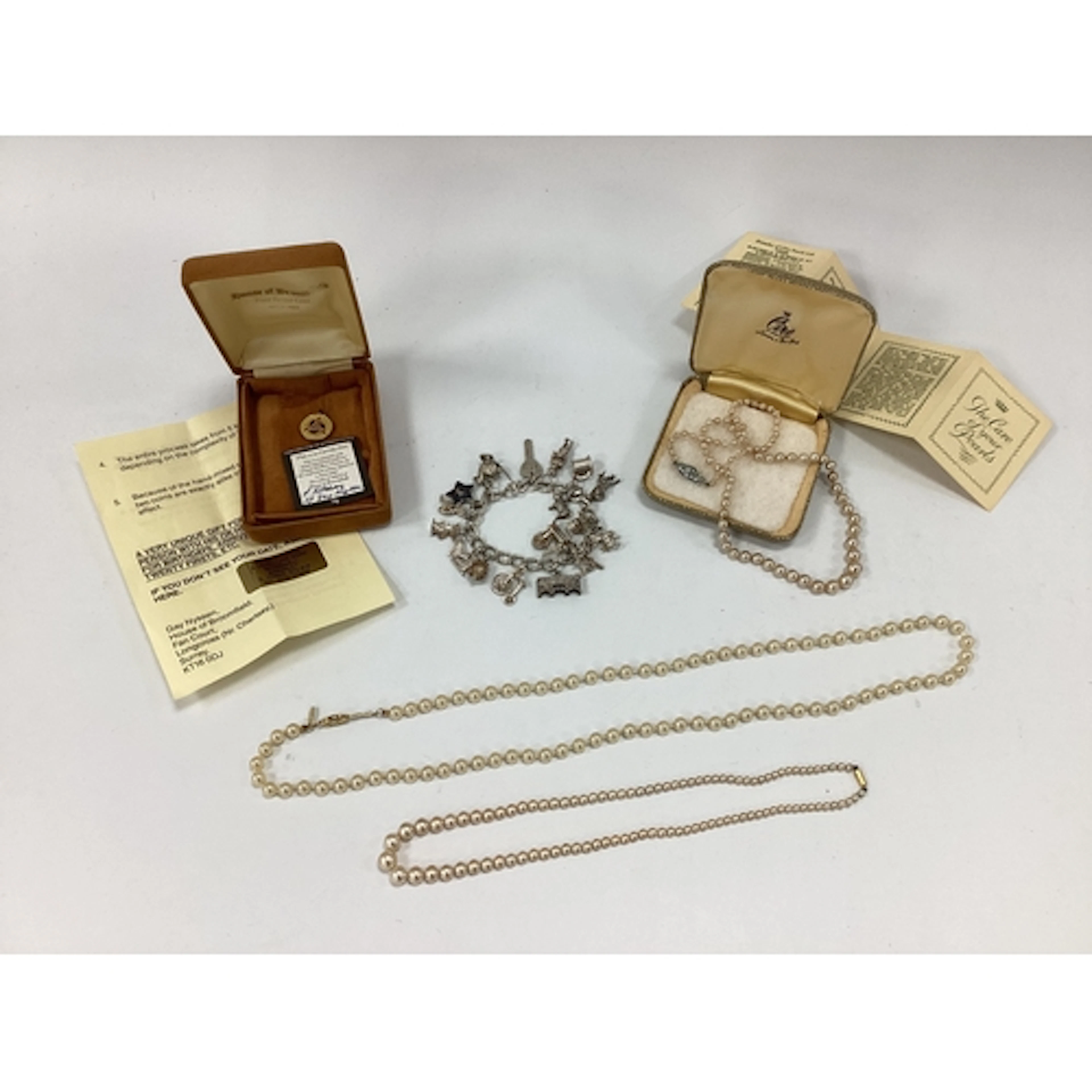 A Curb Link Charm Bracelet, suspending numerous assorted nov...