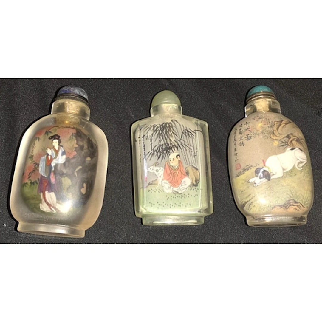 Three Chinese glass reverse painted snuff bottles with stopp...