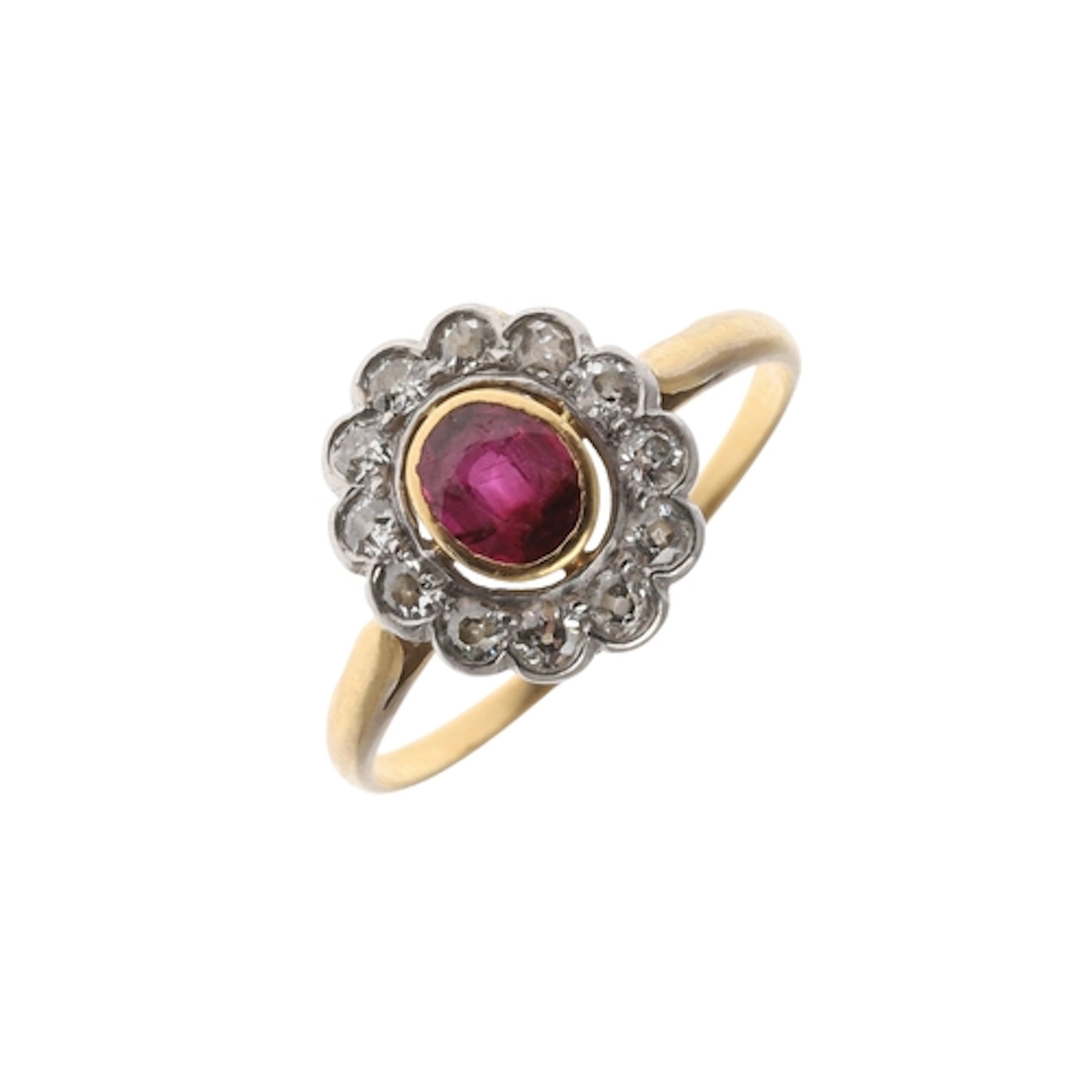 A RUBY AND DIAMOND CLUSTER RING. the oval-shaped ruby is set...
