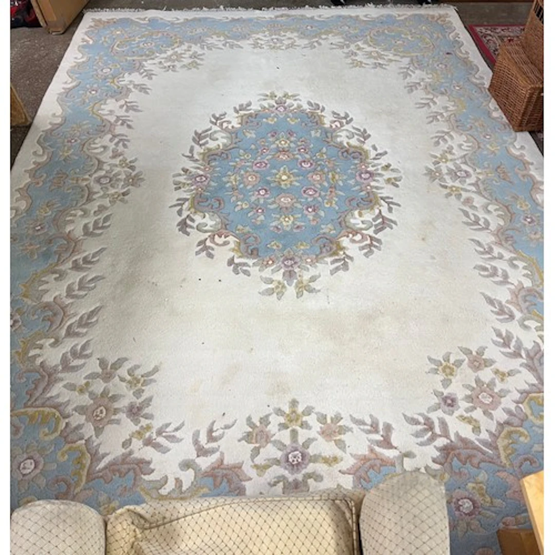 Large blue and white ground floral rug.