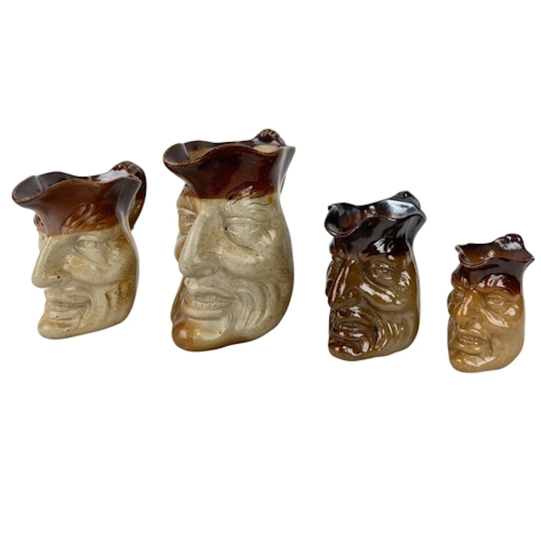 A GRADUATED PAIR OF ENGLISH SALT-GLAZED STONEWARE MEPHISTOPH...