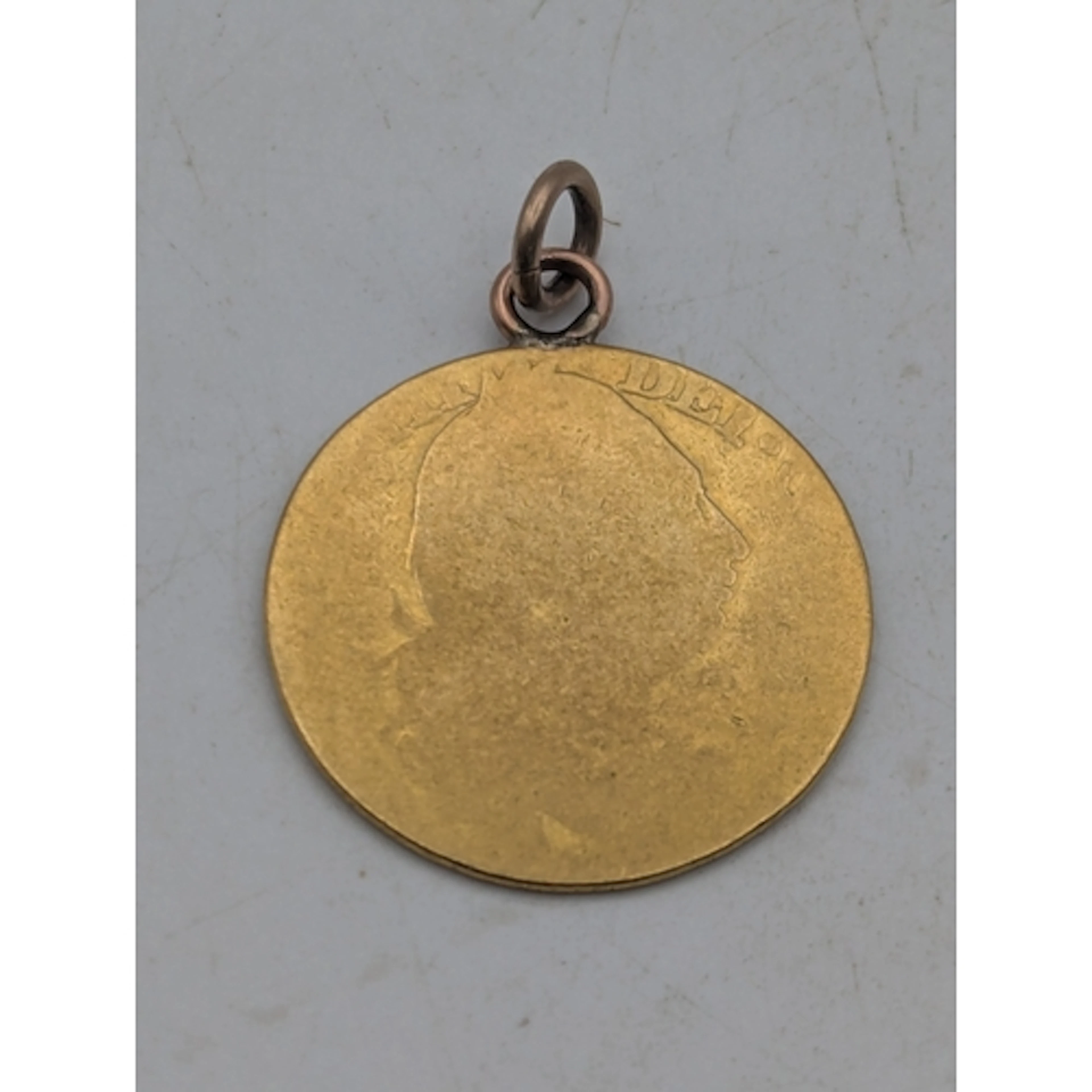 A George III gold guinea on a yellow metal suspension ring, ...