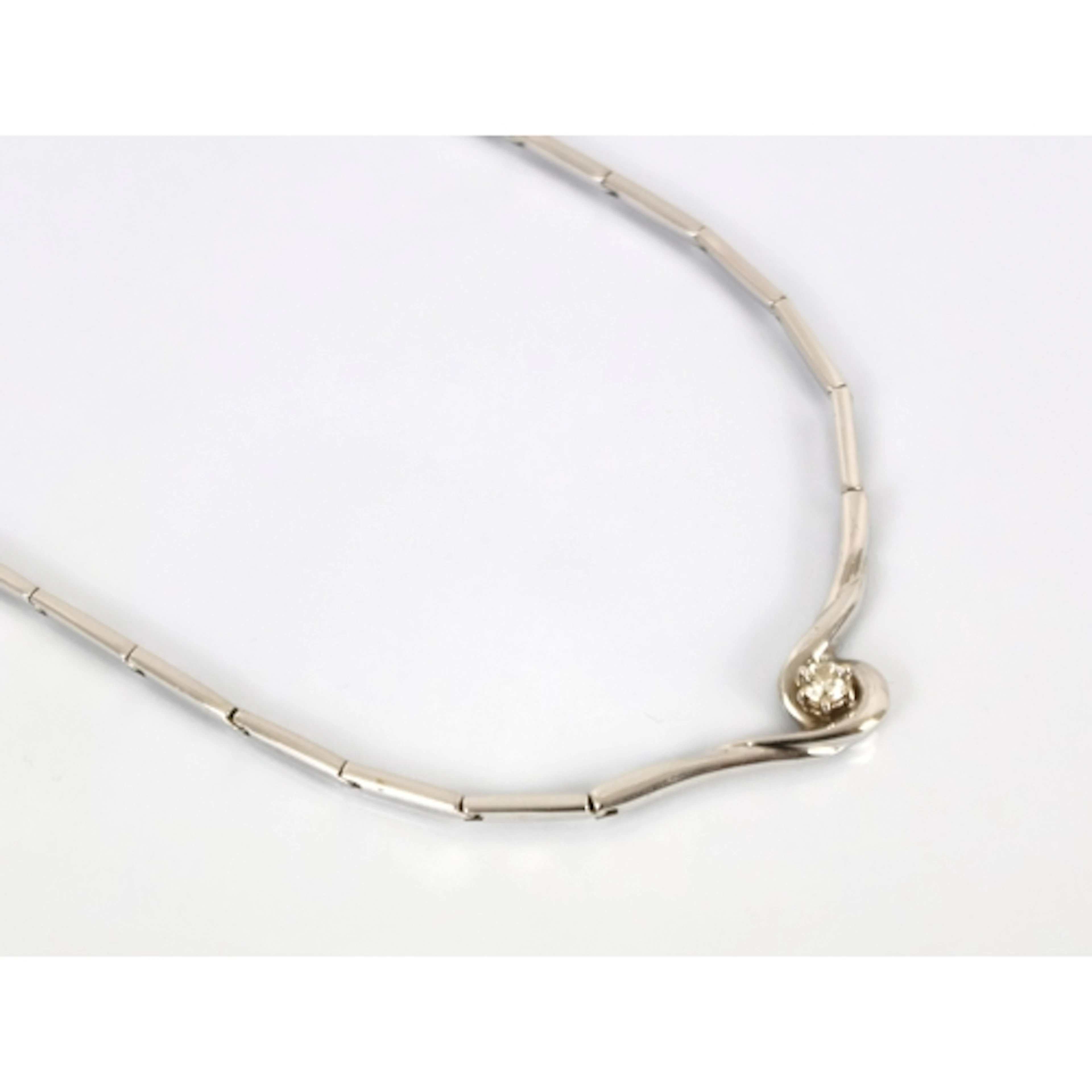 A contemporary diamond set necklace, the central brilliant c...