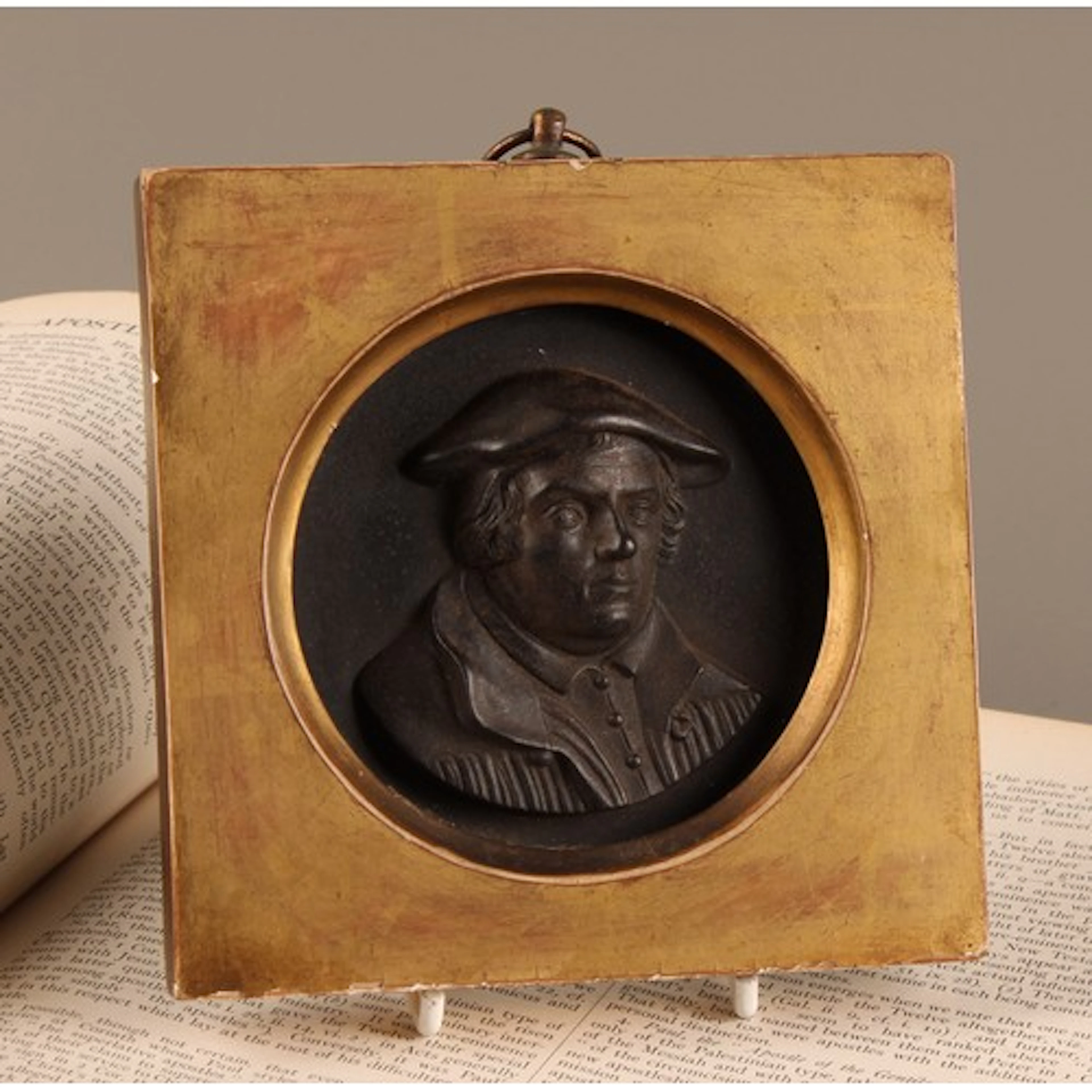 A 19th century black basalt miniature portrait roundel, carv...