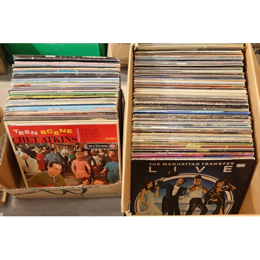 Two boxes containing mixed vinyl records.