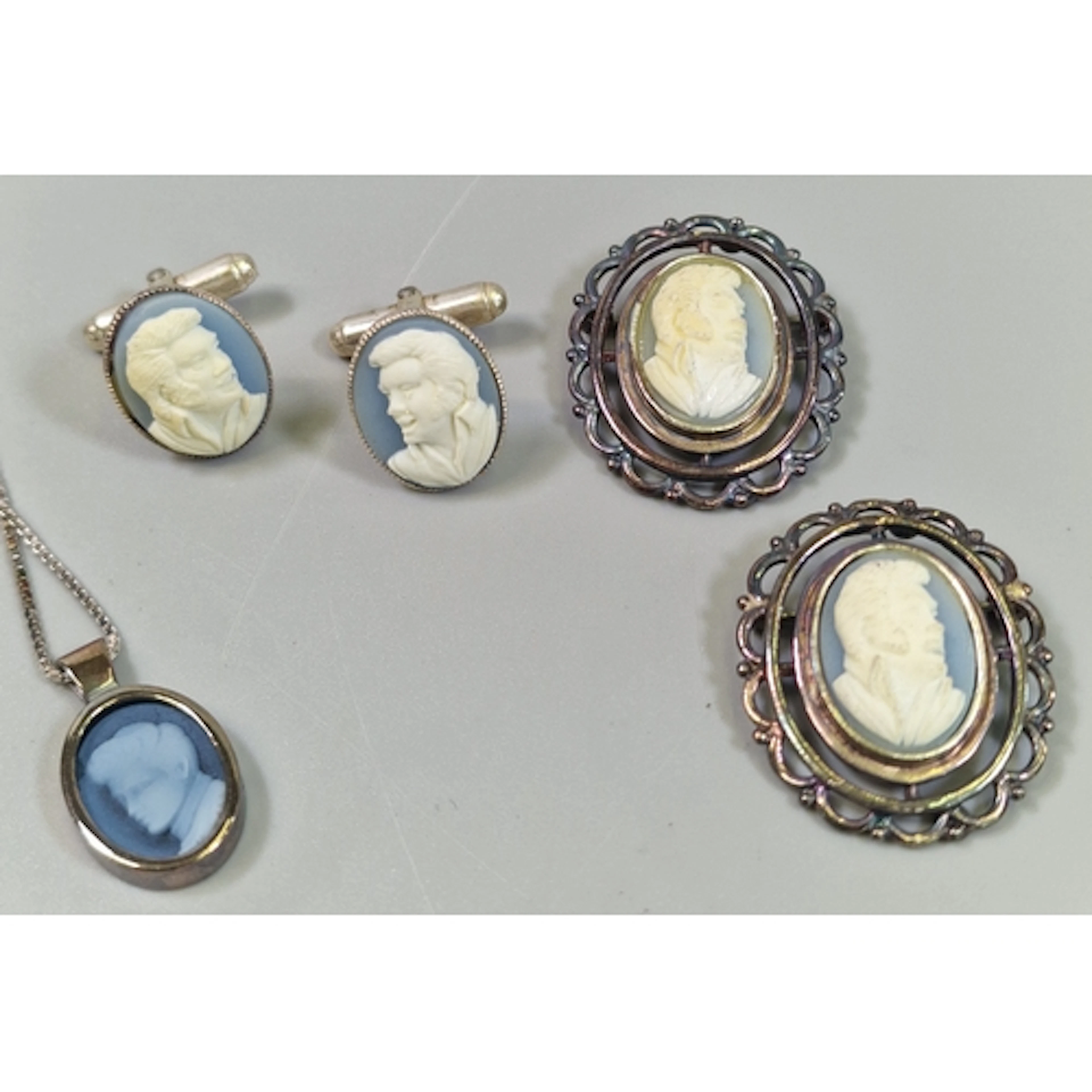 Silver Elvis Presley framed cameo set to include two brooche...