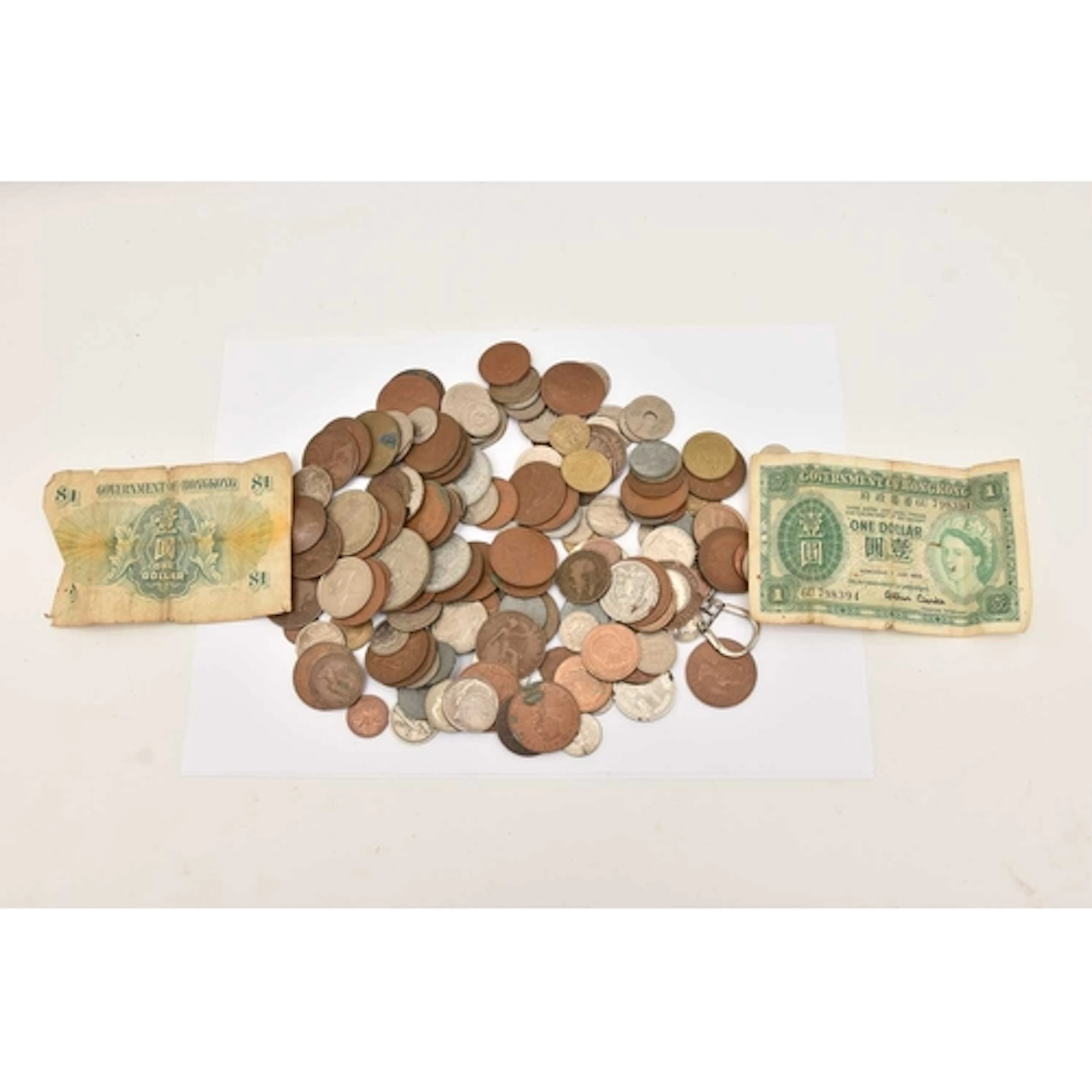 A tub full of mixed UK and foreign coins. A QEII crown, half...
