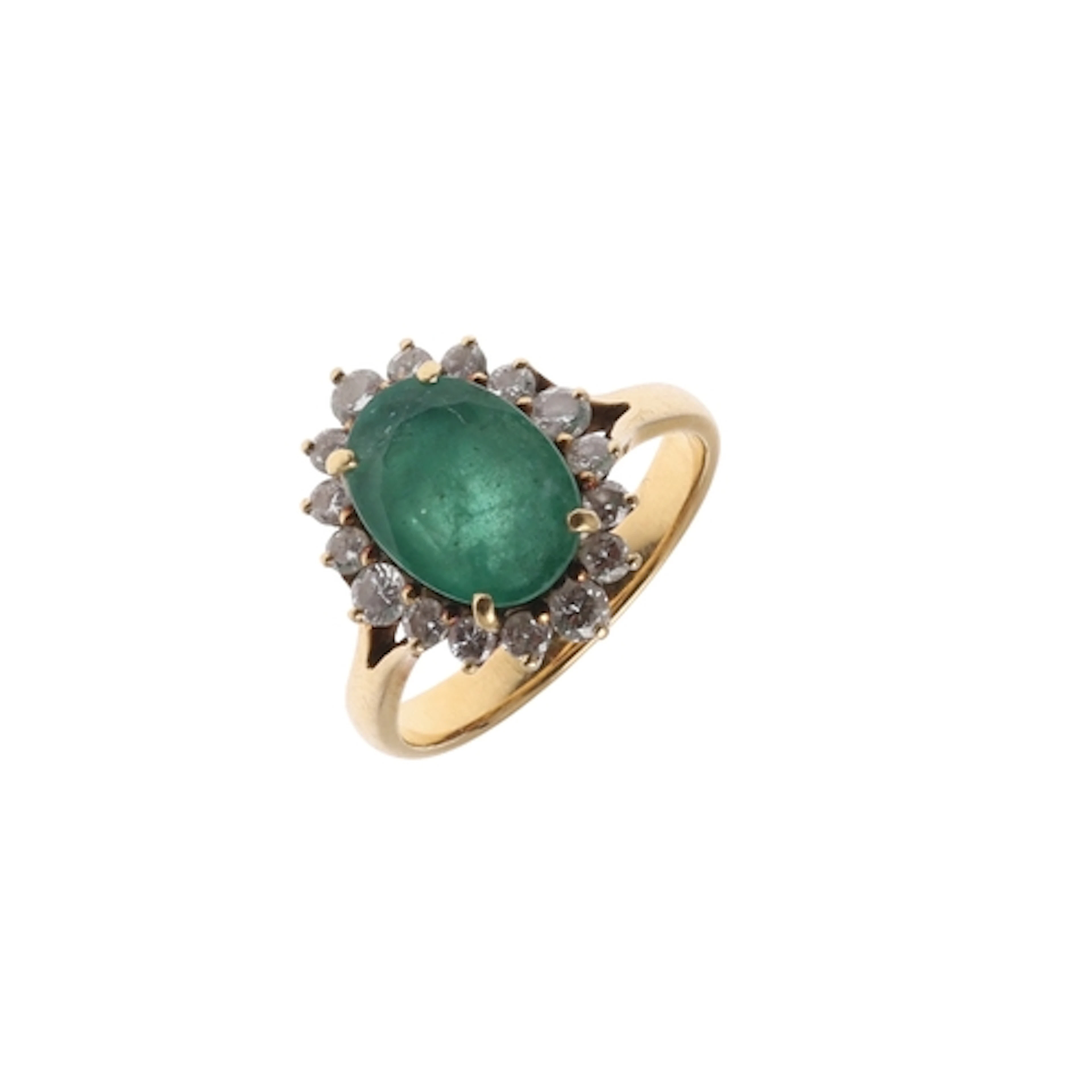 AN EMERALD AND DIAMOND CLUSTER RING. the oval-shaped emerald...