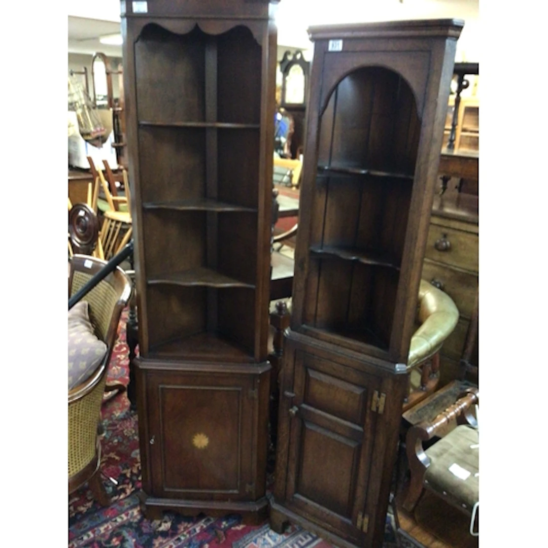 A petite oak corner unit with open shelves above a panel cup...