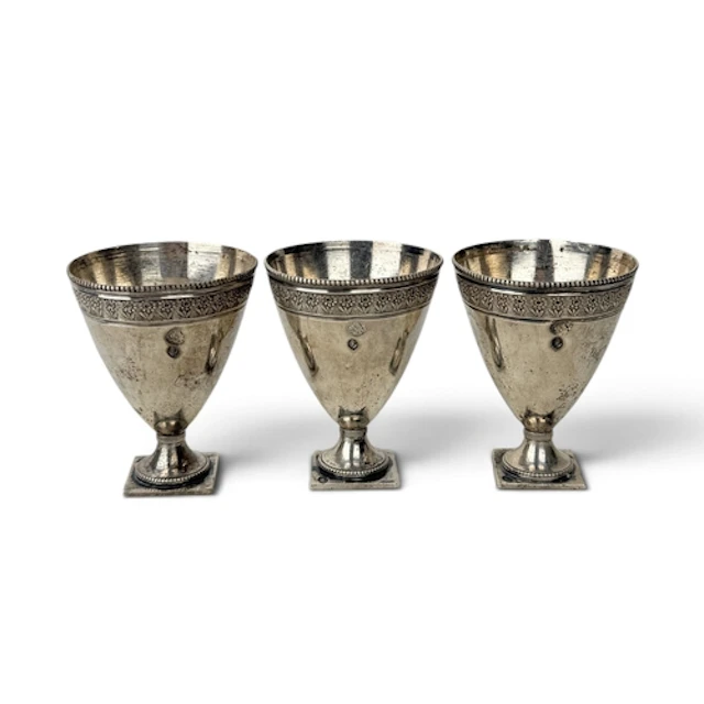 THREE PERSIAN SILVER SHOT CUPS 6cm H each. Total weight: 130...