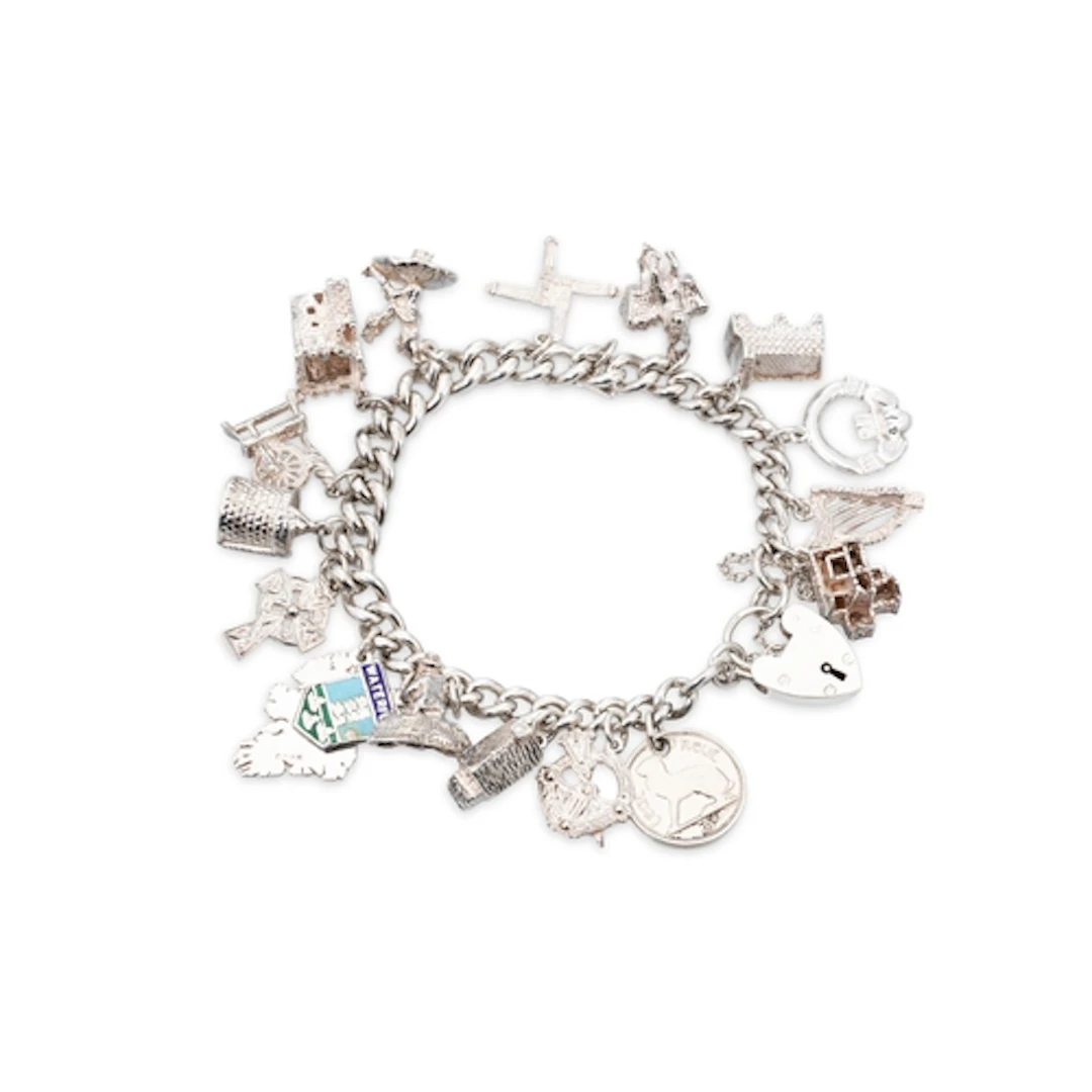 A STERLING SILVER CHARM BRACELET, set with various charms, g...