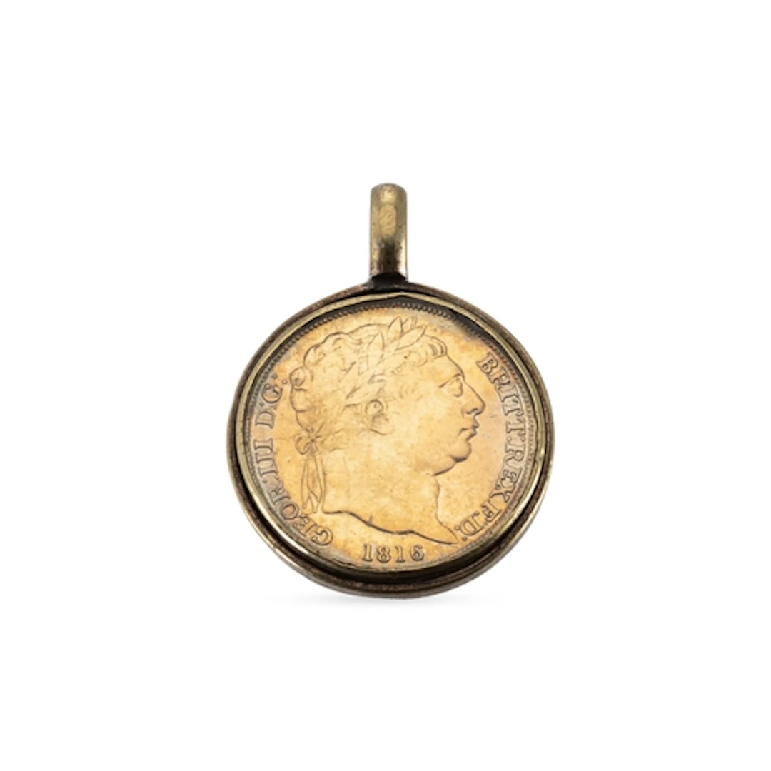 A GEORGE III COIN, 1815, in a glazed pendant mount