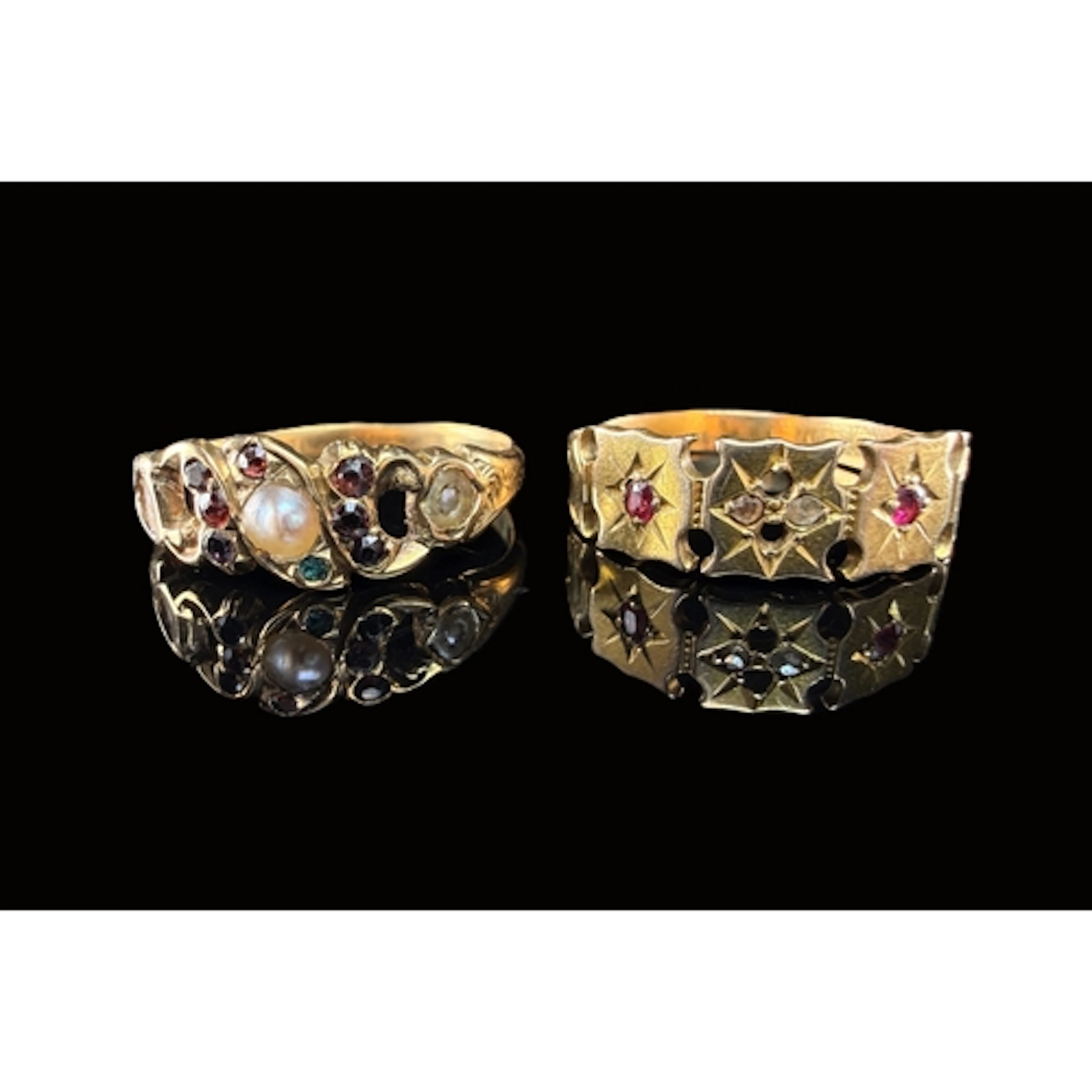 A yellow metal ring set with small rubies and seed pearls si...