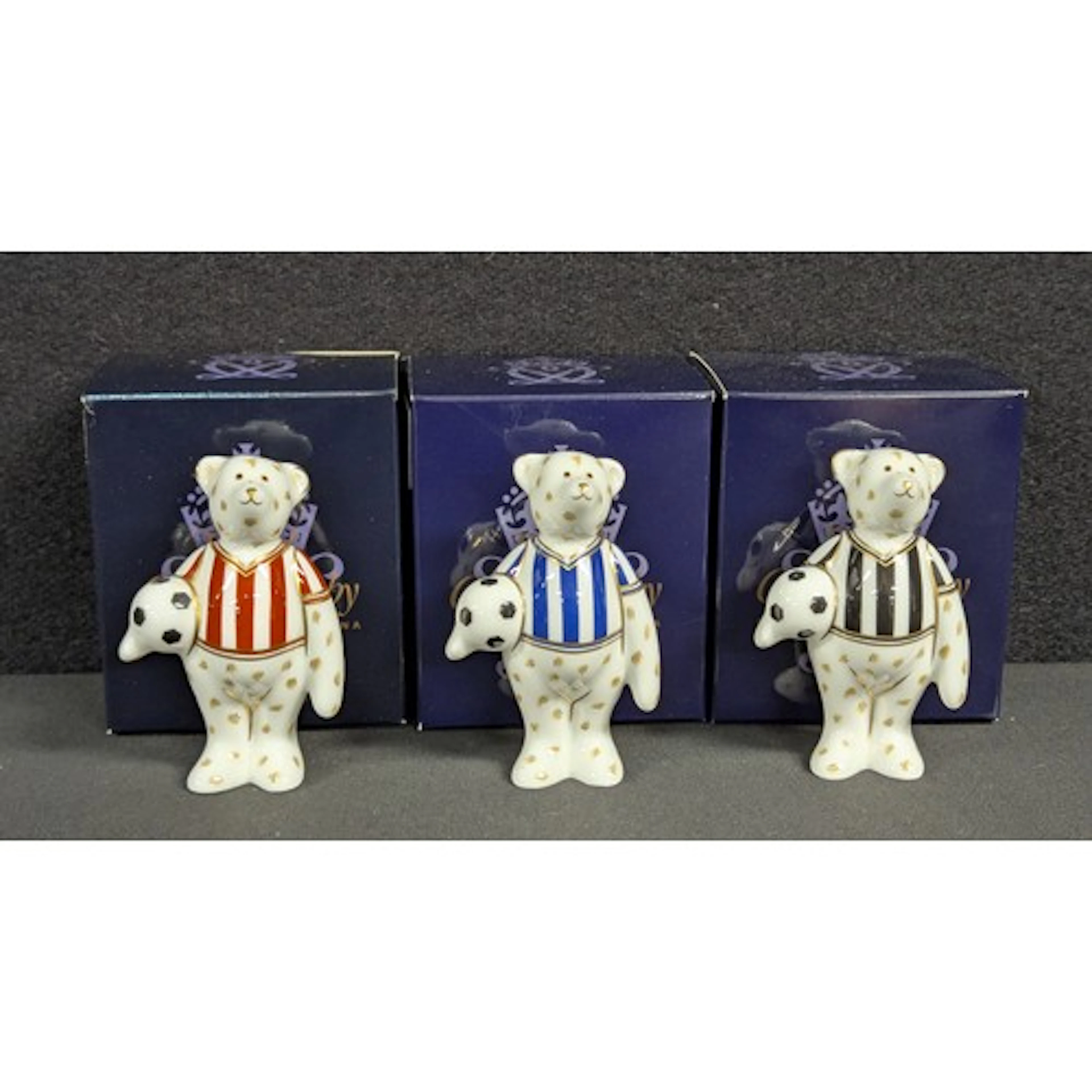 A set of three Royal Crown Derby miniature Footballer Bears,...