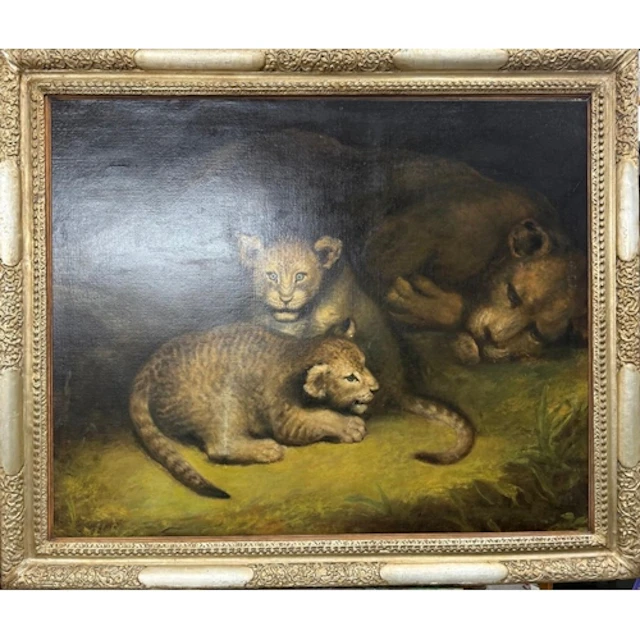 An oil on canvas of a resting lioness and her cubs in a gilt...