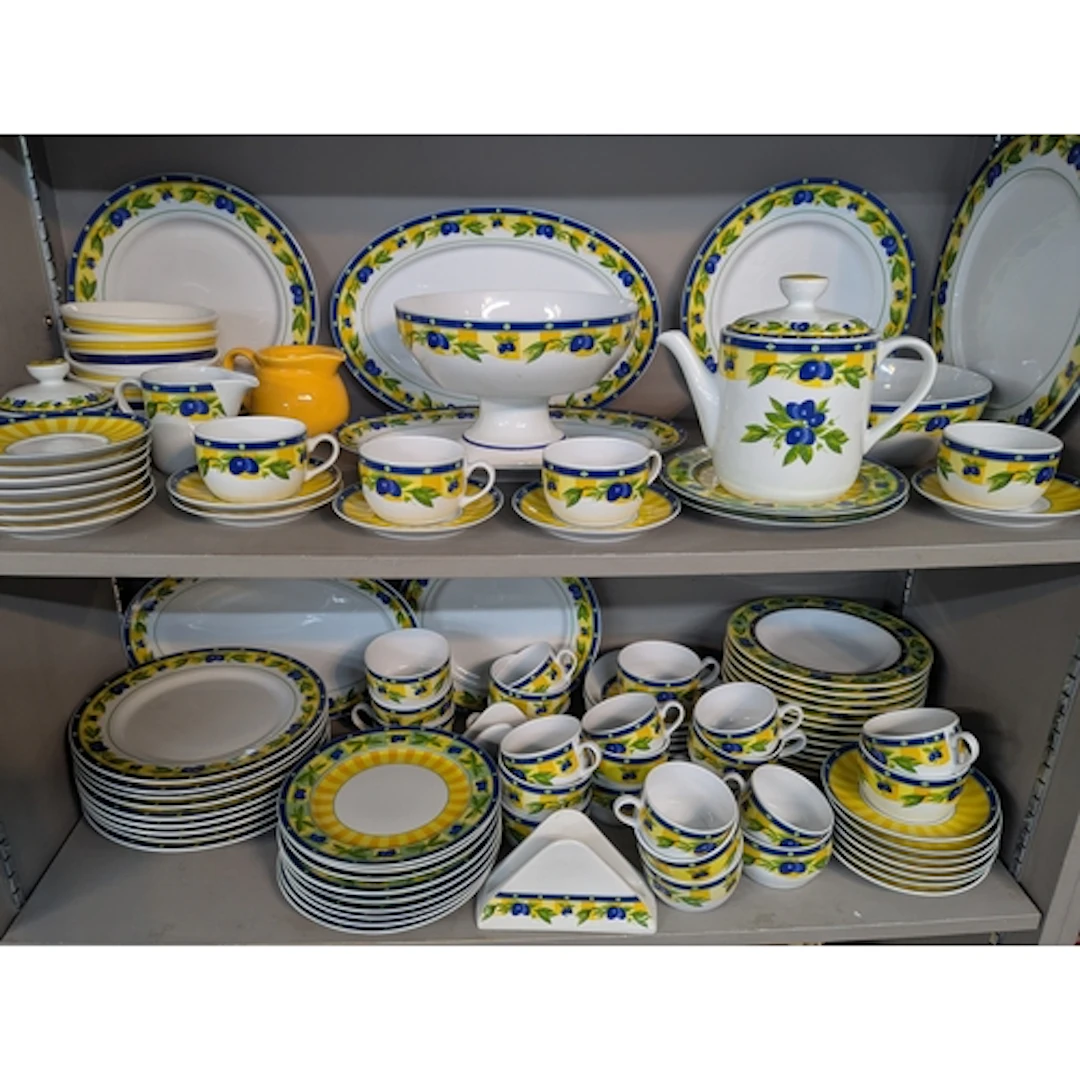 A modern dinner and tea service decorated with Olives having...