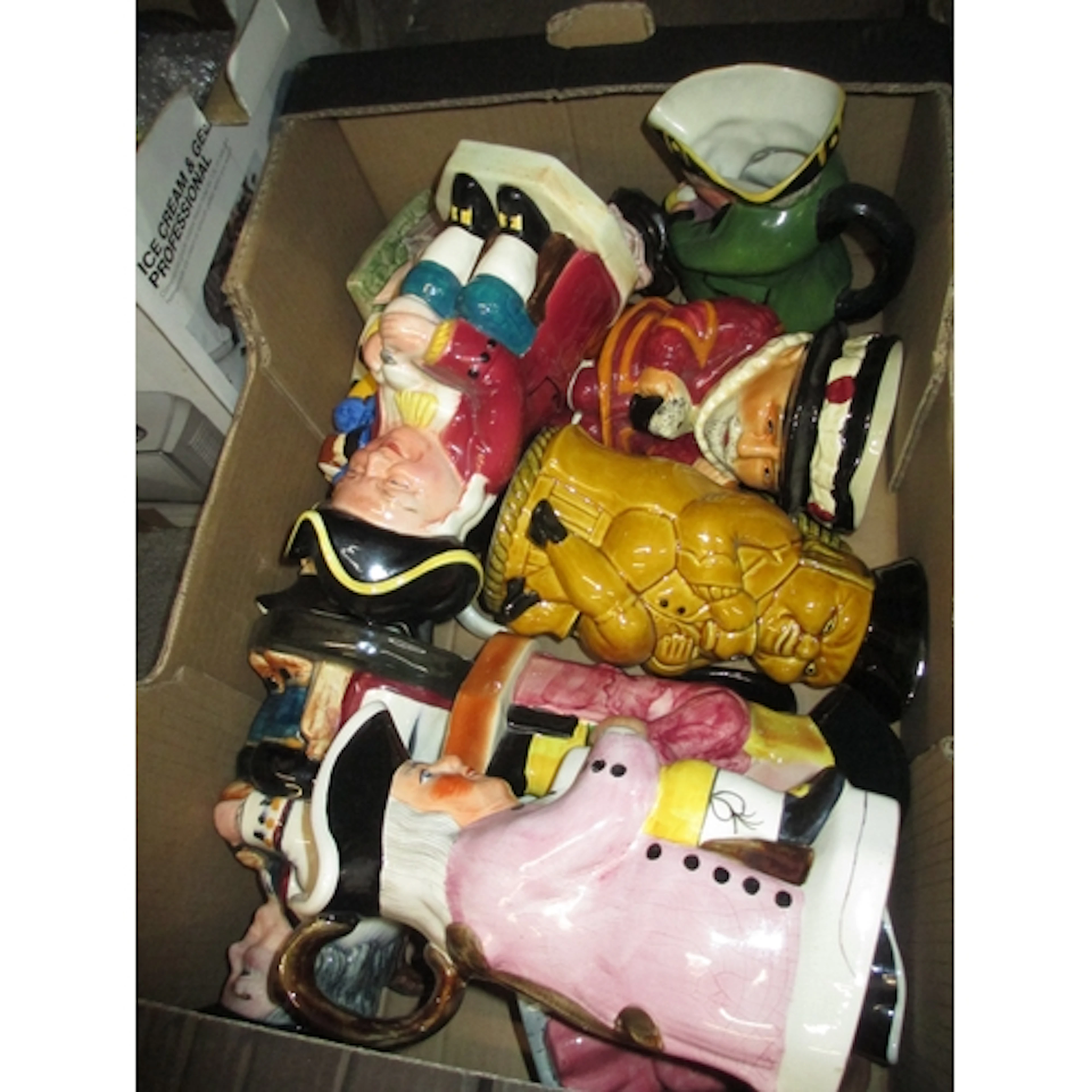 Box containing a quantity of various toby jugs