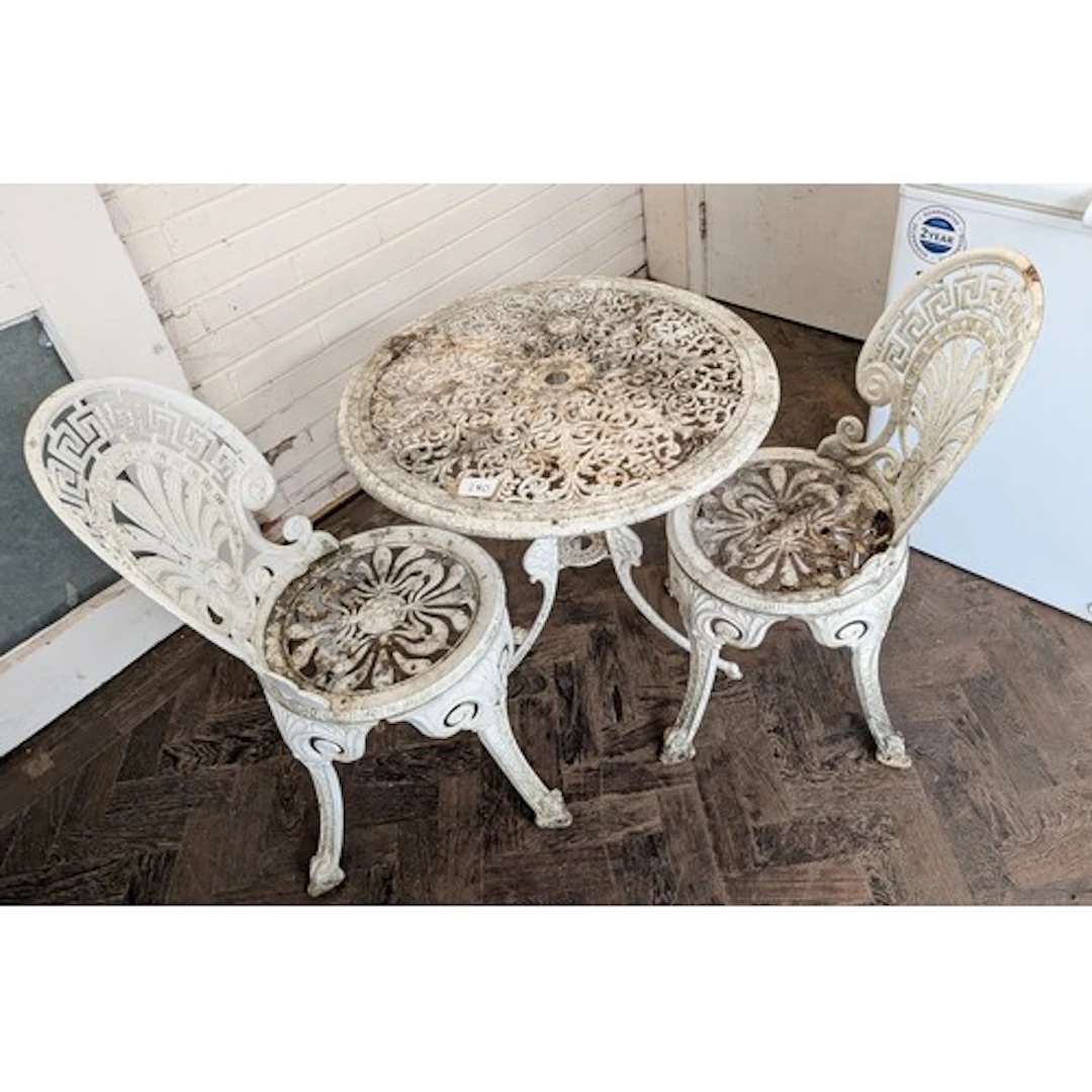 A white painted metal garden table and two matching chairs