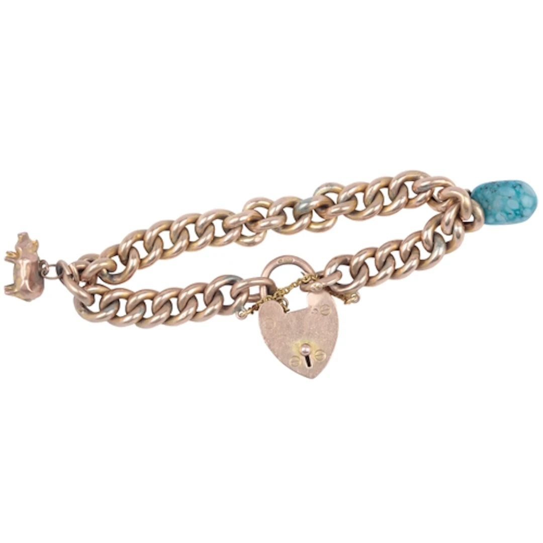 An Edwardian gold charm bracelet, early 20th century, of cur...