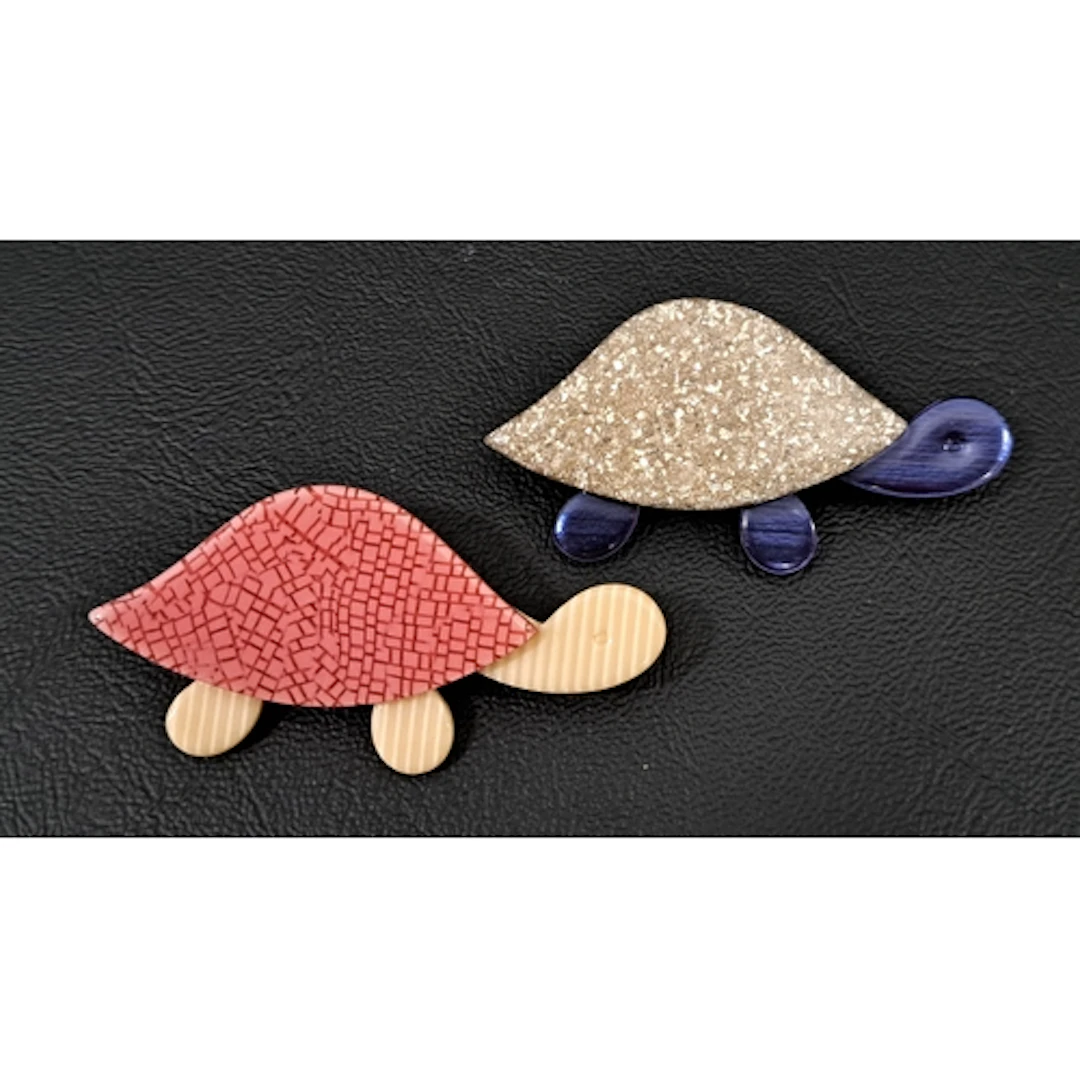 TWO LEA STEIN TORTOISE BROOCHES one with silver glitter shel...