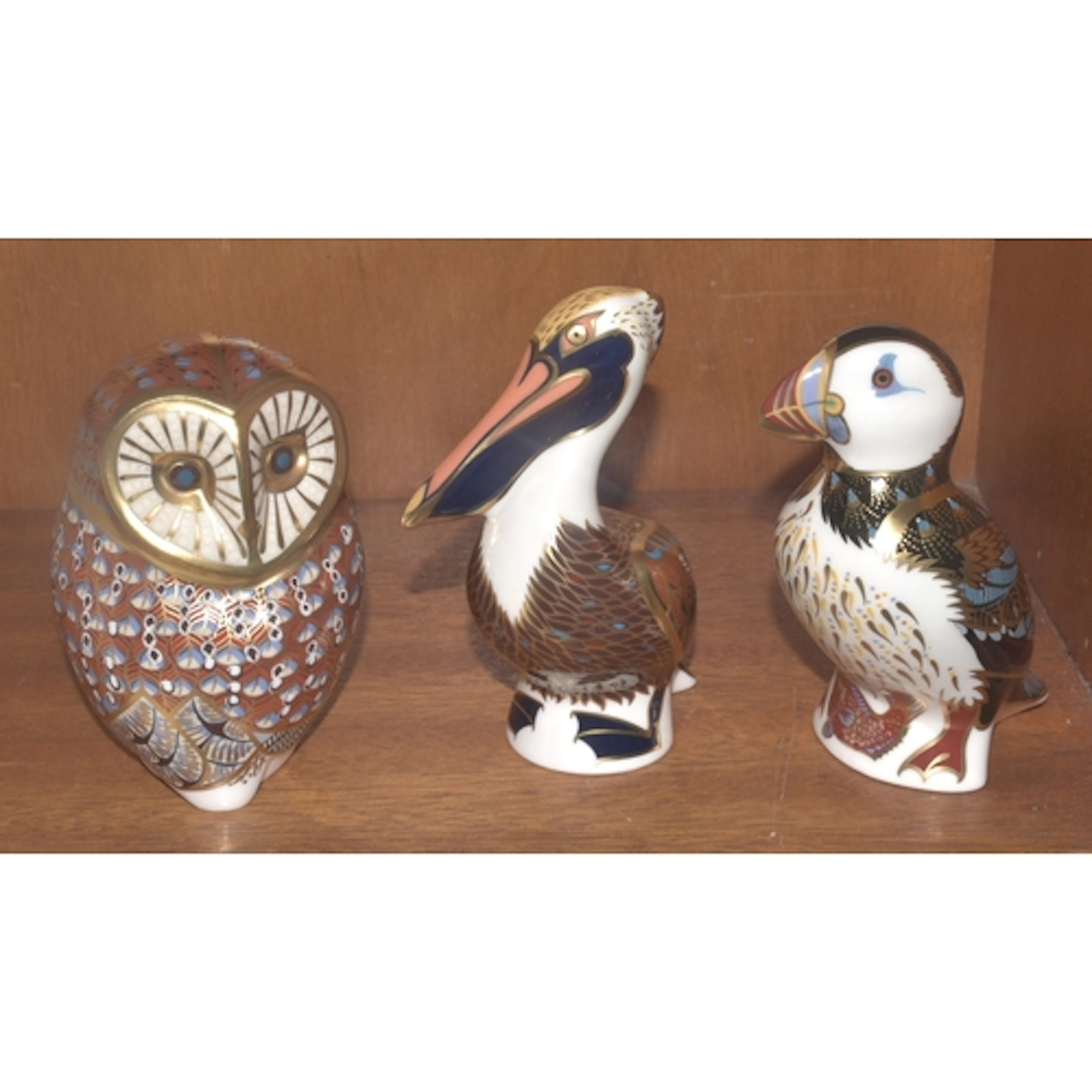 Three Royal Crown Derby paperweights: Brown Pelican, Puffin,...