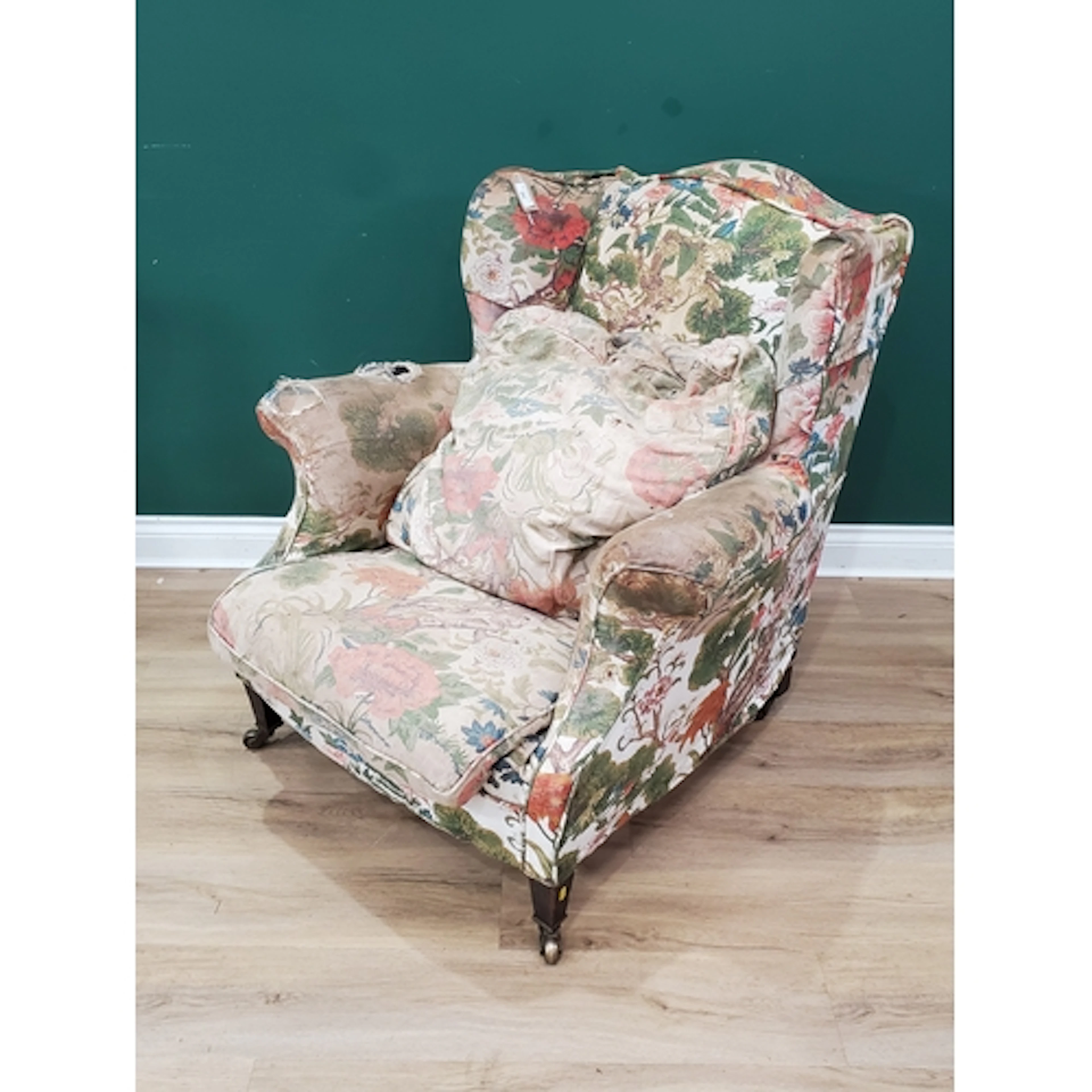 An antique floral upholstered low seated wing back Armchair ...